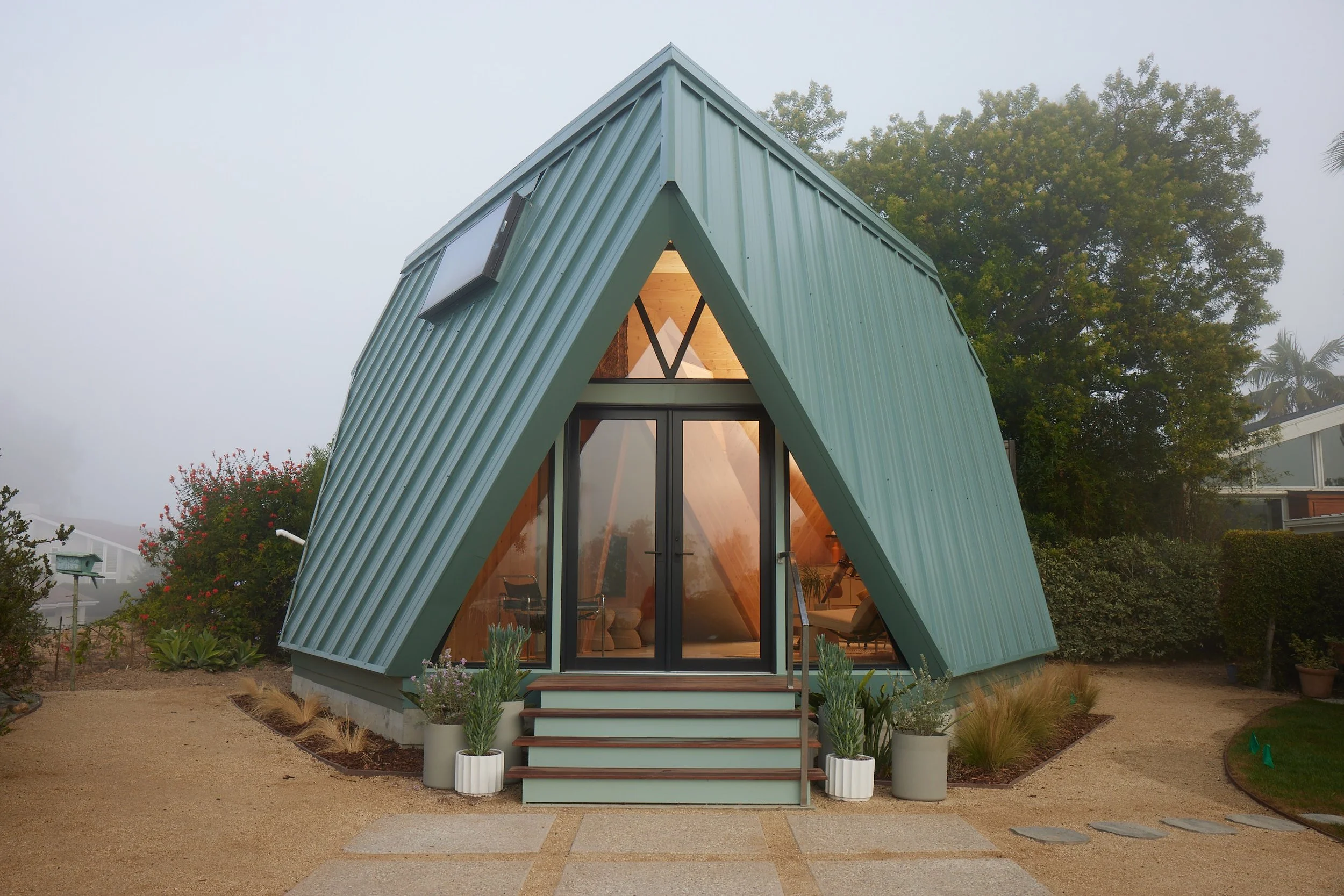 A modern take on the traditional A-frame house using CLT modular prefab construction.