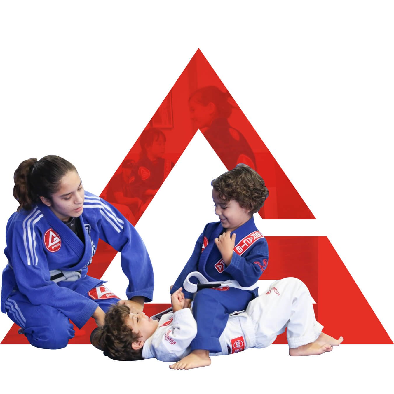 Two children and an adult practicing Brazilian Jiu Jitsu on a mat with a large red triangle logo in the background. The adult and one child are wearing blue gis, the other child is wearing a white gi.