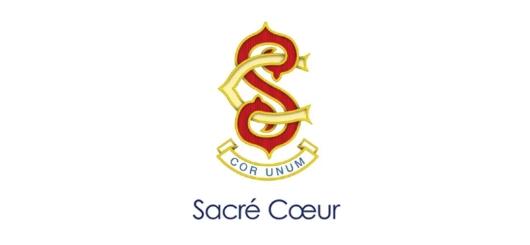 A logo with intertwined red and gold initials, a Latin motto banner, and the words "Sacré Coeur" below.