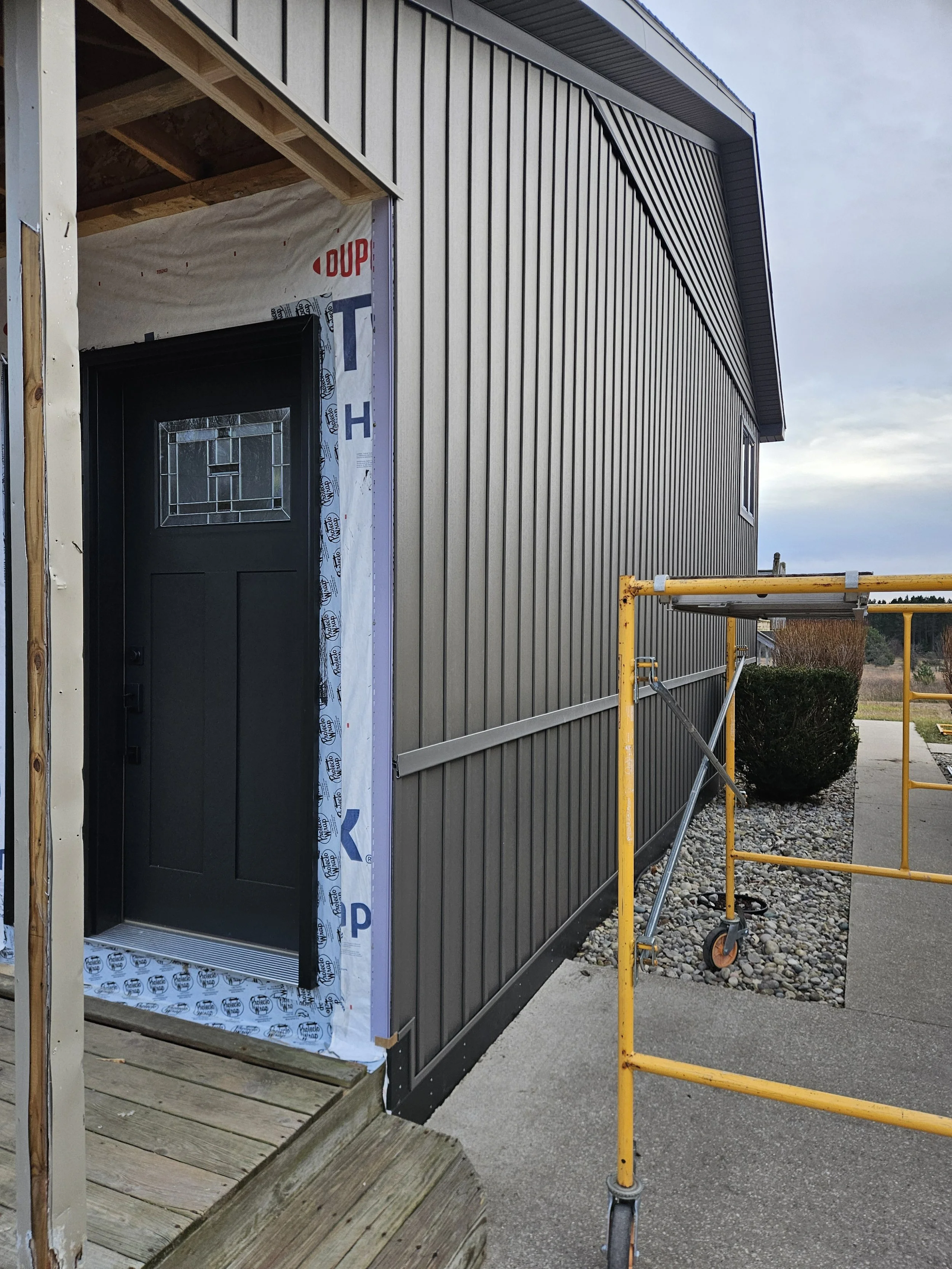 New Vinyl Board & Batton Siding, Soffit, Fascia, Window, and Doors. This one turned out sharp!