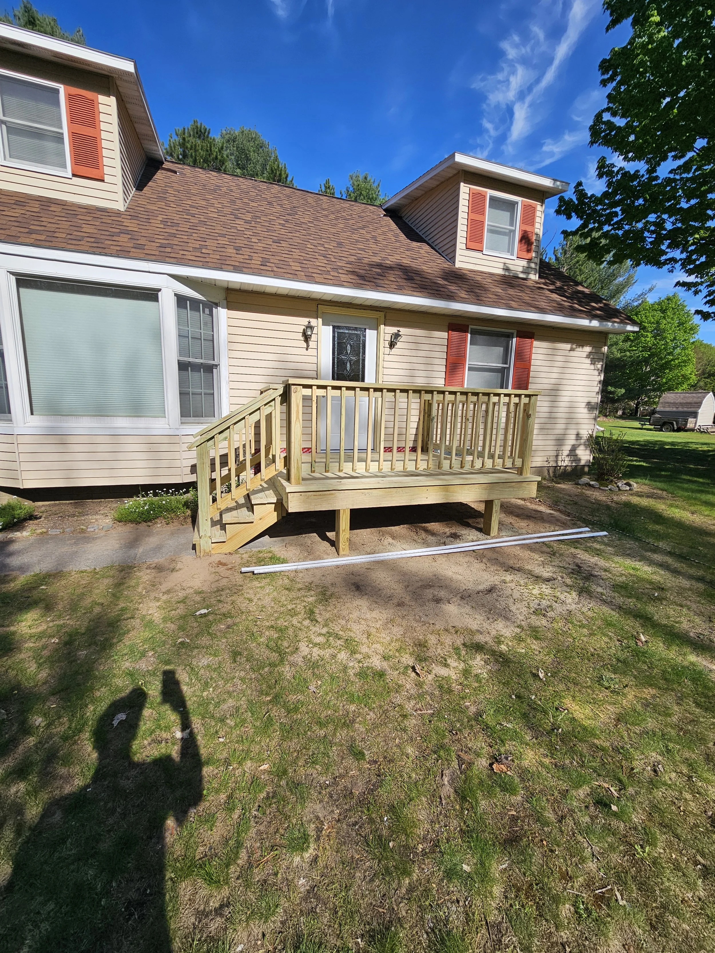 This customers original deck was destroyed from a large ice dam that let loose in the spring. The new deck is larger and has a much safer code complaint hand rail and railing installed. 