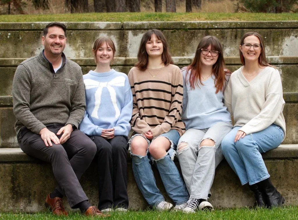 A family sitting together for a posed photo.