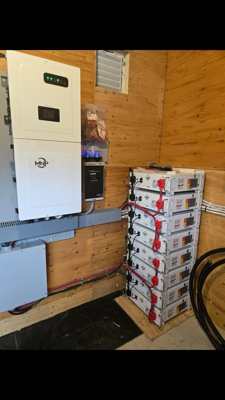 MidNite inverter with stacked lithium batteries indoors for off grid site