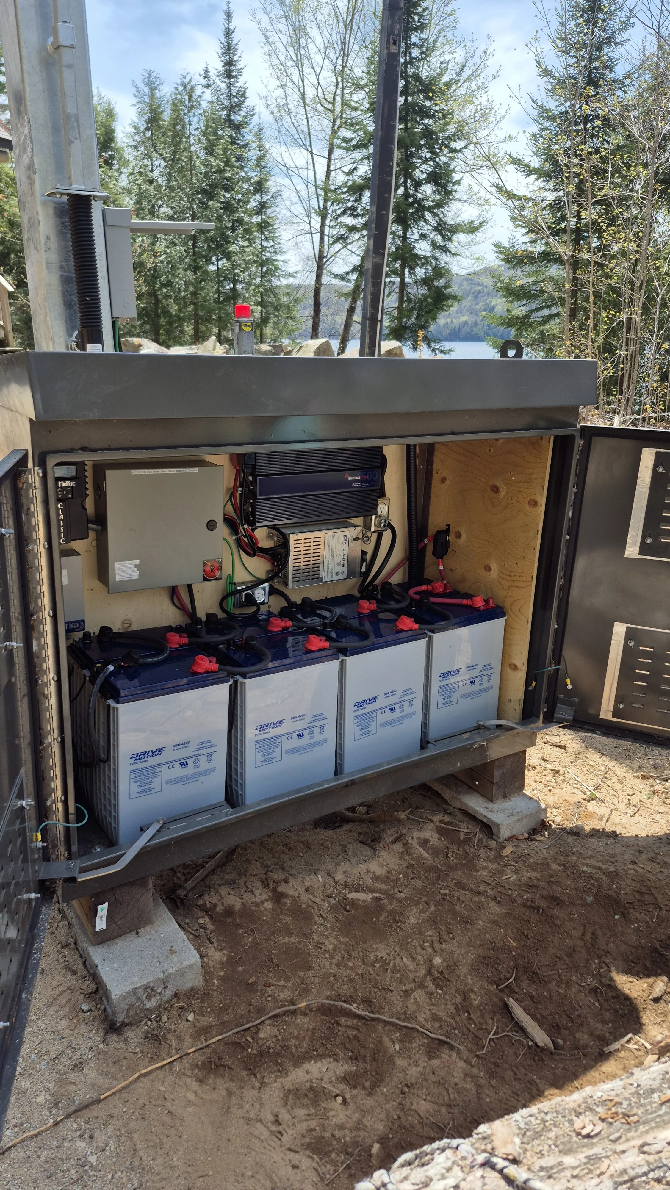 Lead-acid batteries in a ventilated outdoor enclosure with pre-assembled solar power system