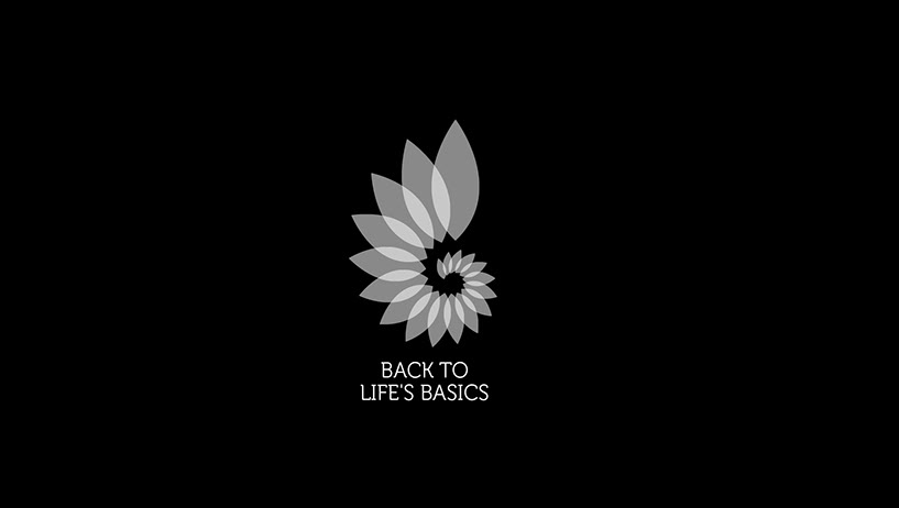 Black background with a grey flower-like logo in the center. Text at the top says 'Back to Life's Basics' and 'Health Organization'.