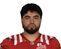 Portrait of a man wearing a red football jersey with white accents