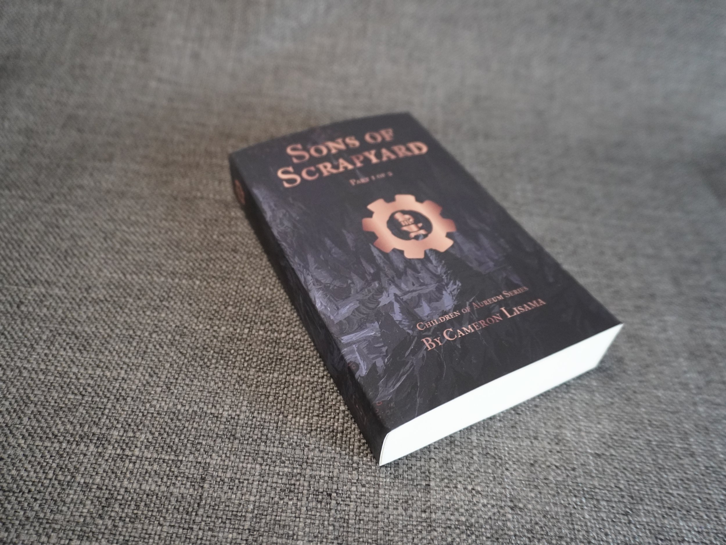 This is a product photo for the science fantasy action novel series, Sons of Scrapyard part 1 pocket edition, by Cameron Lisama.
