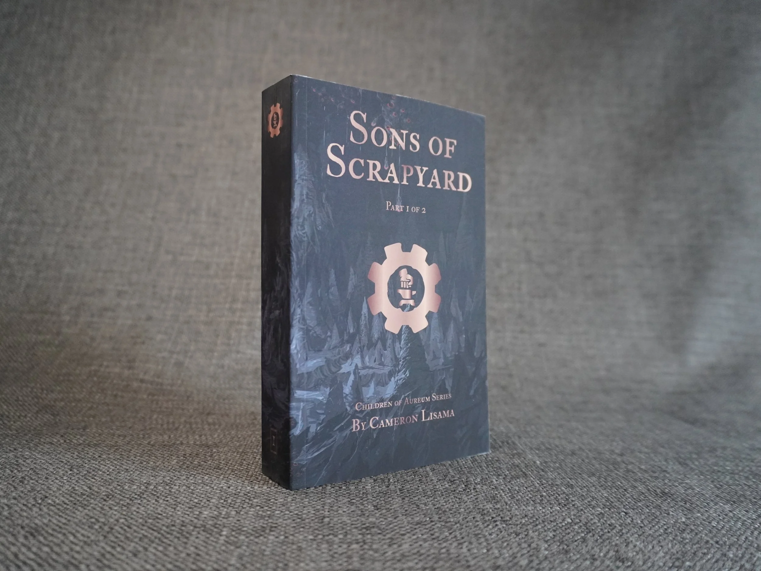 This is a product photo for the science fantasy action novel series, Sons of Scrapyard part 1 pocket edition, by Cameron Lisama.