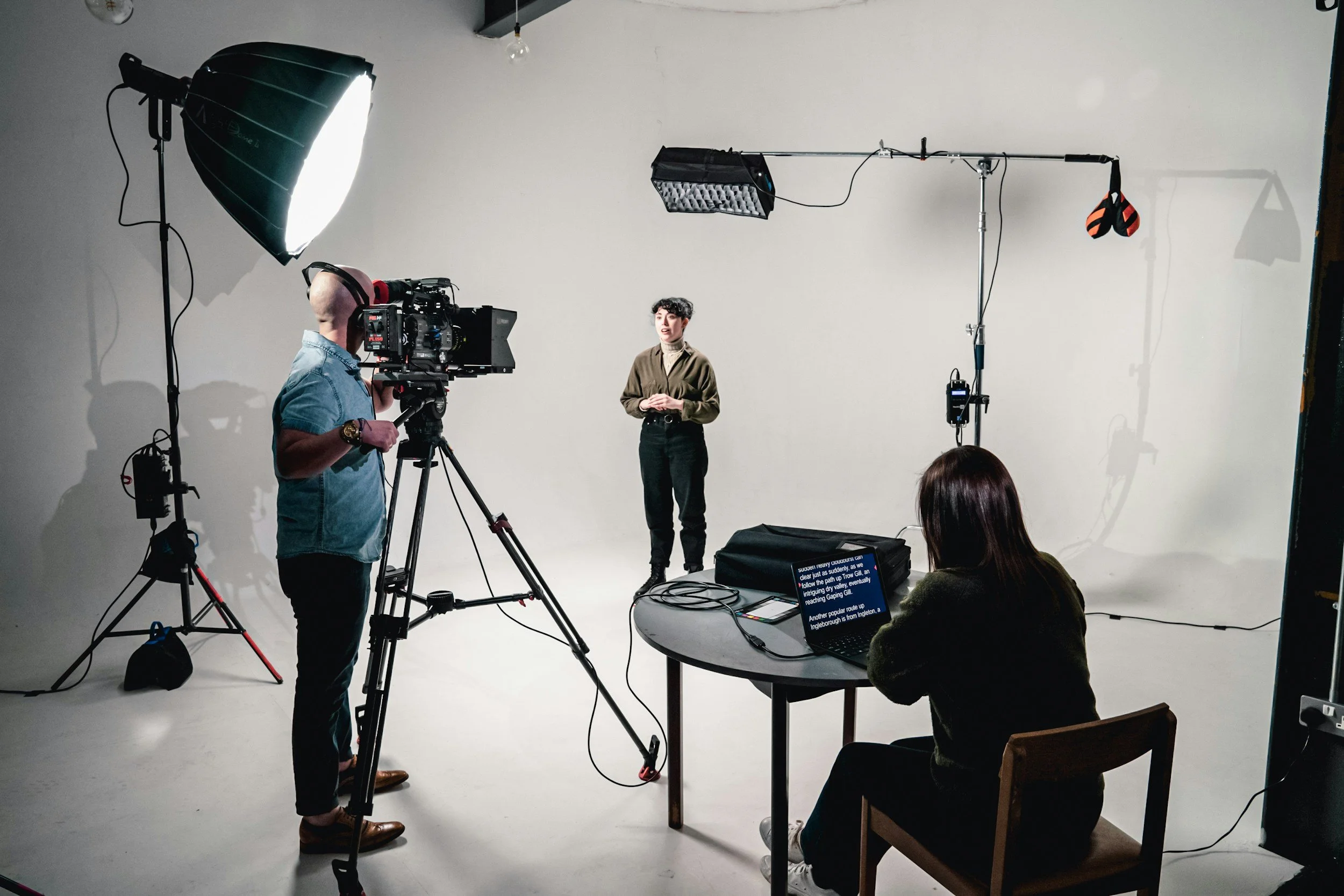 A woman speaks on camera in a production studio