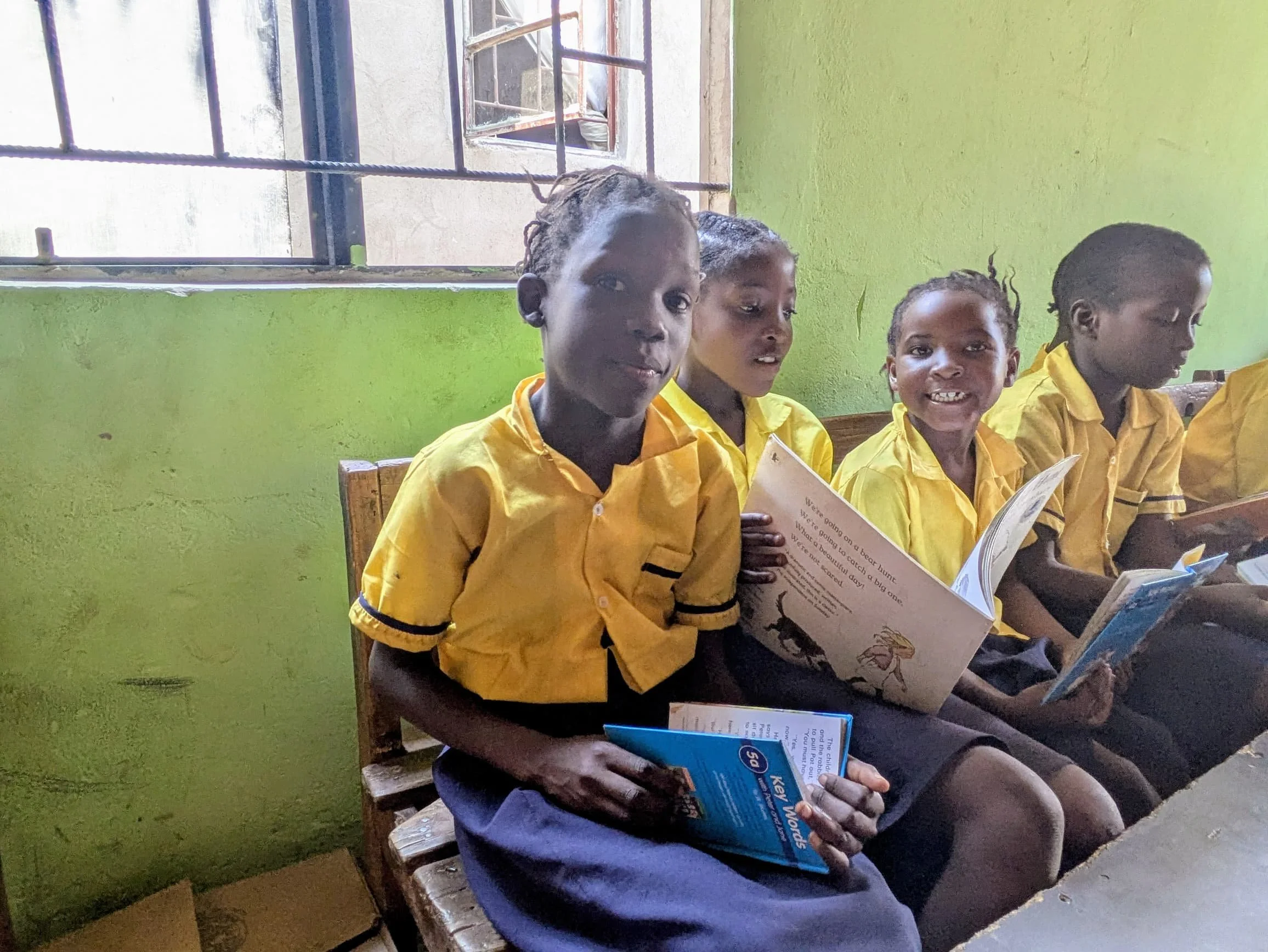 Blessing, Leticia and Mwape enjoy their books