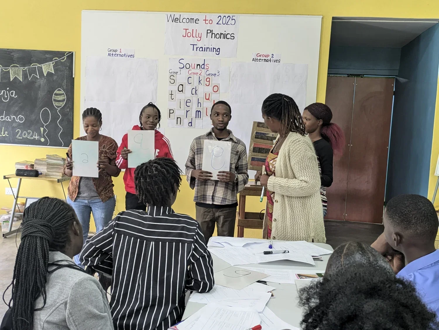 Teachers practice blending and segmenting using phonics strips