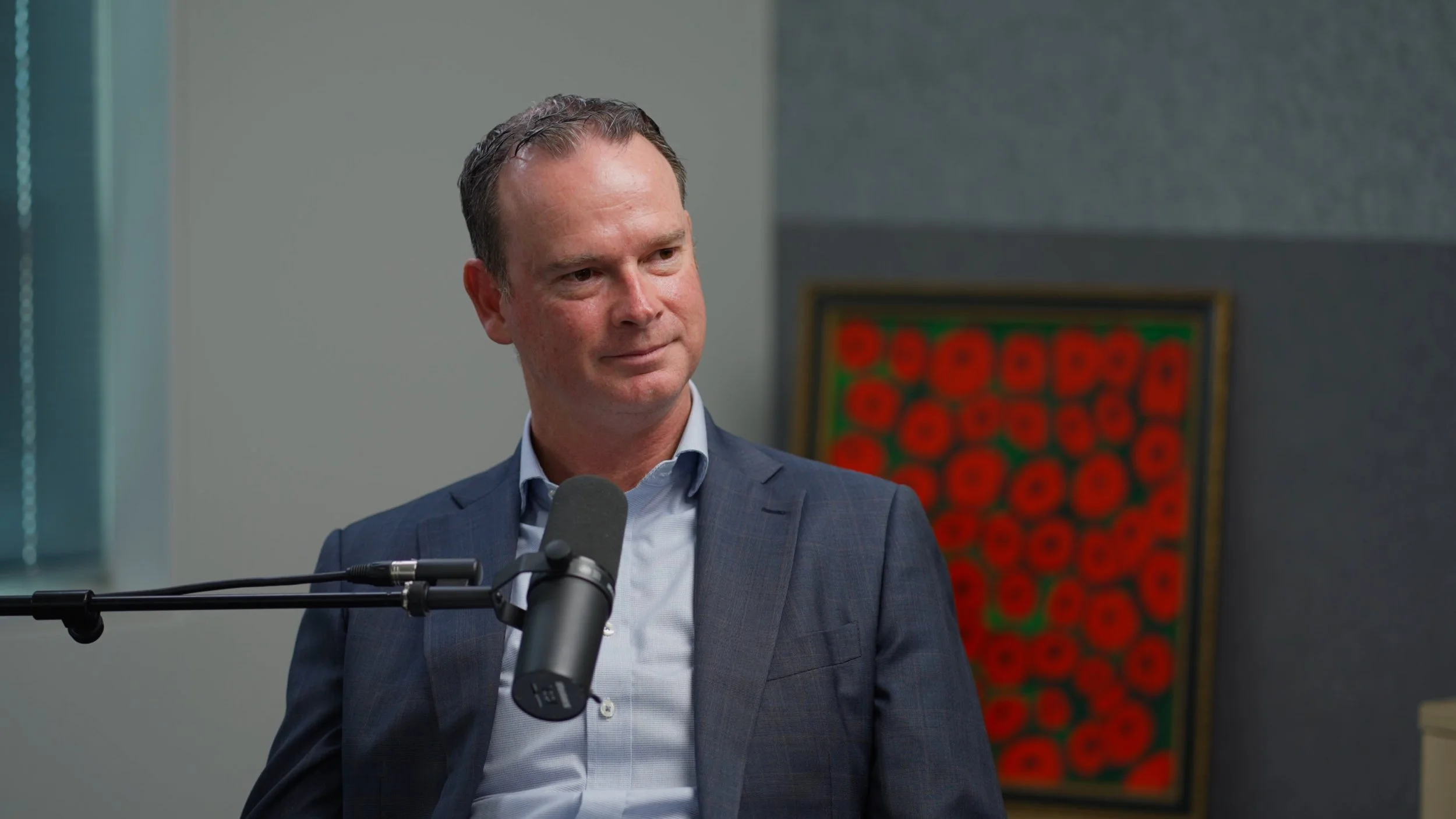 A close up shot of talent from the set of a professional podcast.