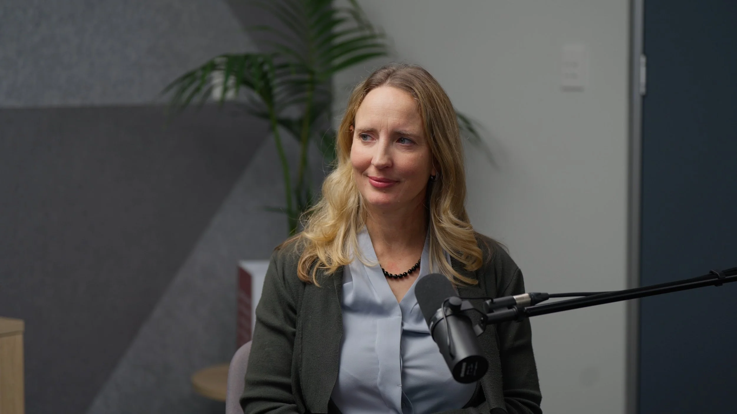 A close up shot of talent from the set of a professional podcast.