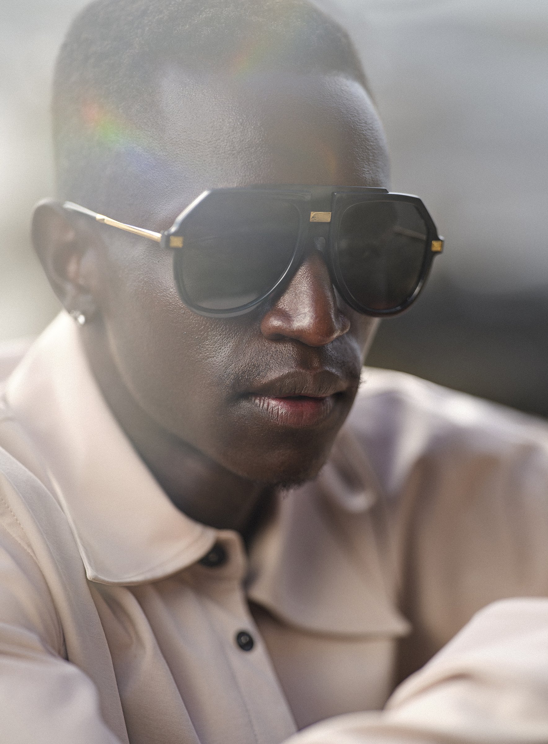 Peter Bol photographed for Esquire Magazine, styled in sunglasses and captured in natural light with cinematic flare.