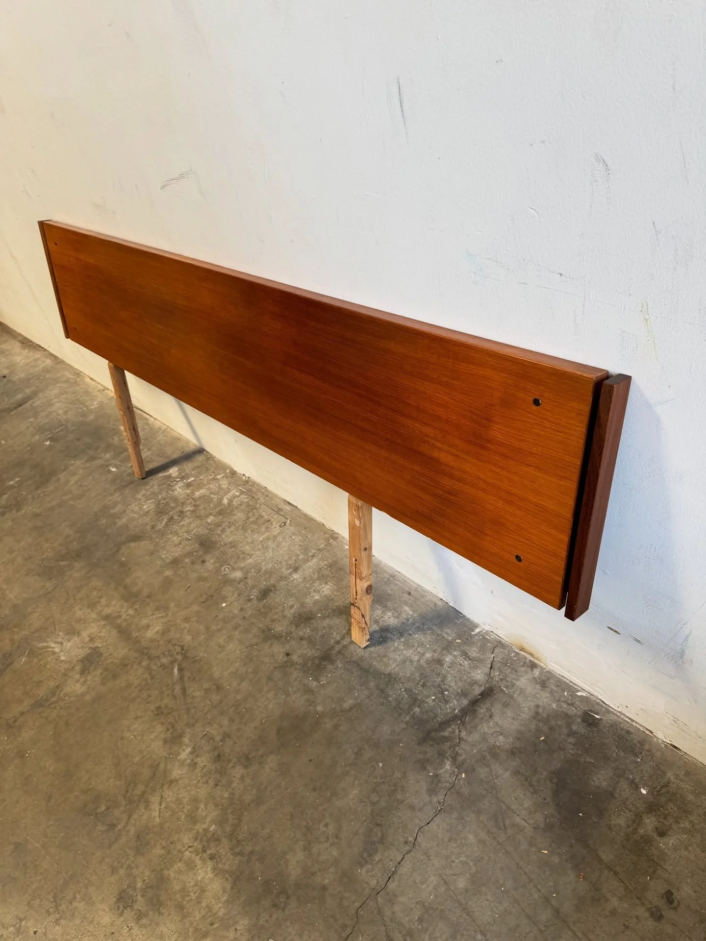 This headboard features a rich teak finish with a sleek, minimalist design, characteristic of the 1960s era. 

Made in Canada, this headboard showcases high-quality craftsmanship and natural wood grain. 

Size: 82 3/4x1 1/2 x33 1/2&rdquo;
16&rdquo; -
