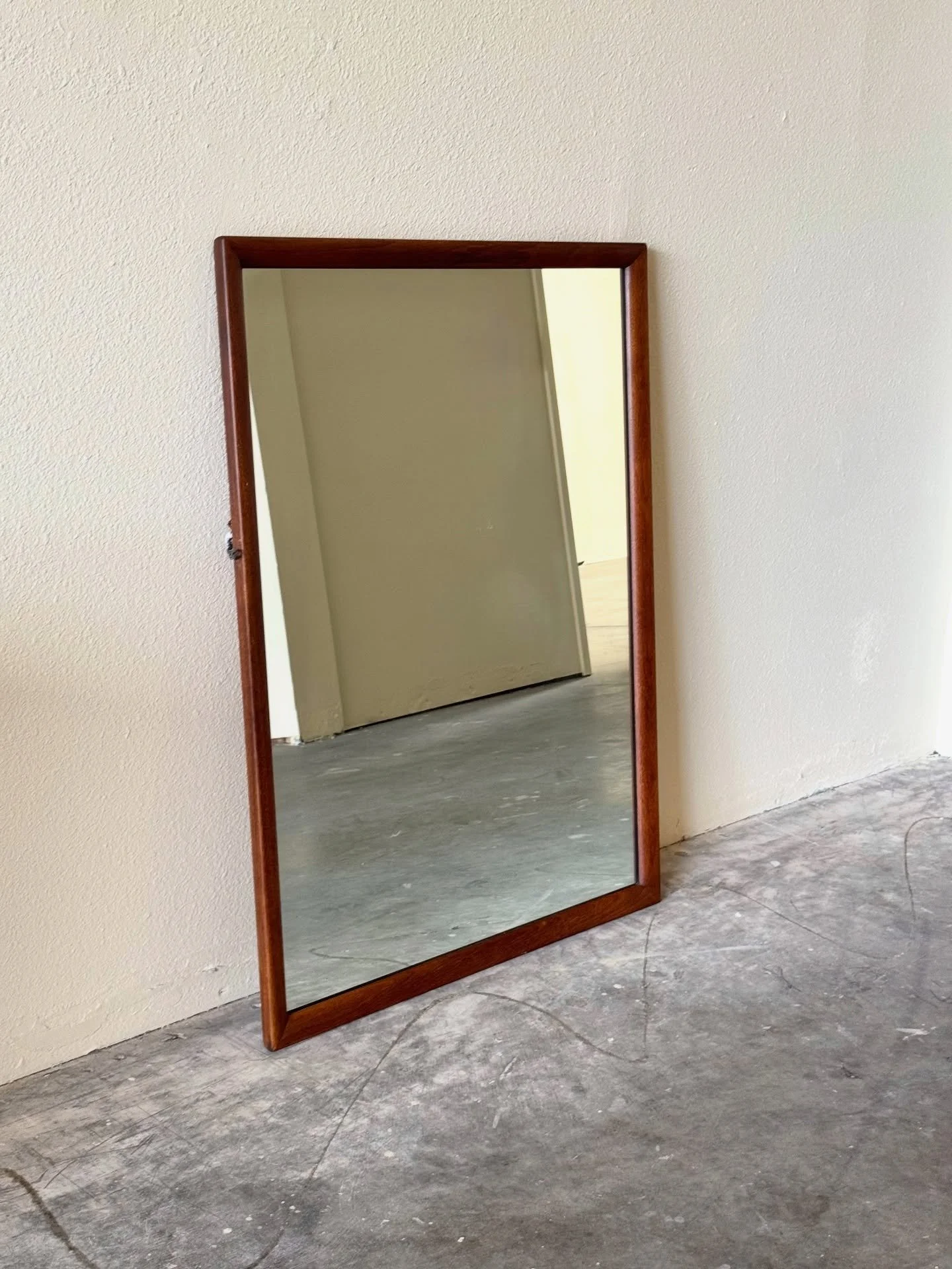Stunning vintage mirror by Henredon, crafted from rich walnut wood in the 1960s. This piece features a classic mid-century design with a sturdy frame and a clear, reflective surface, perfect for adding a touch of elegance to any room. 

32.5x1.25x42.
