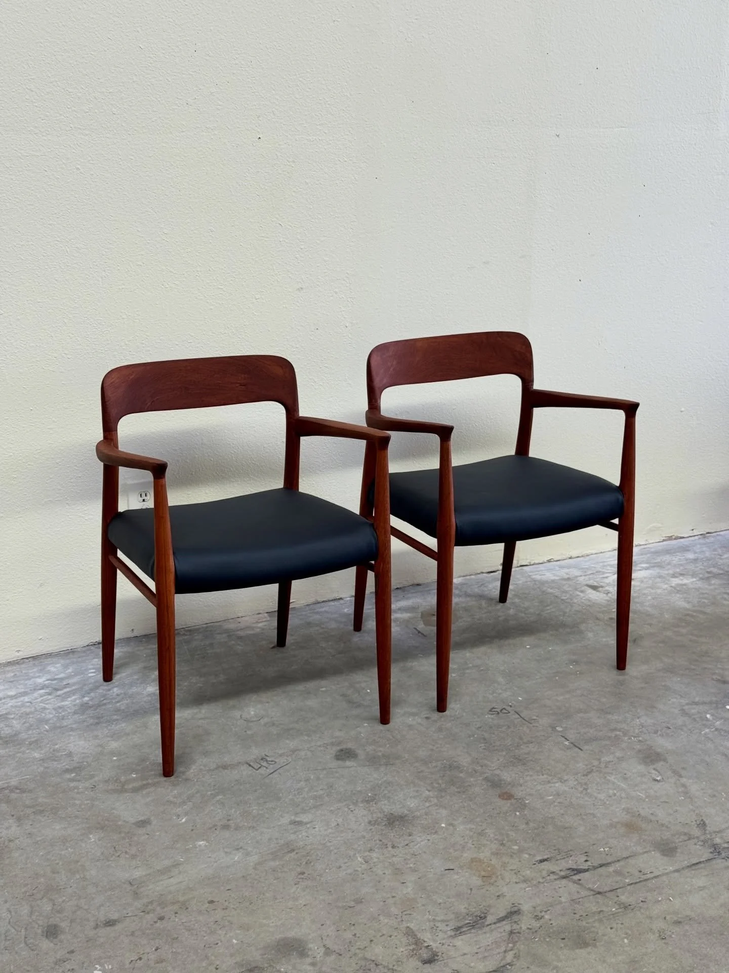 Beautiful pair of authentic Niels Otto M&oslash;ller Model 56 armchairs, designed in 1954 and crafted in Denmark by J.L. M&oslash;ller M&oslash;belfabrik. These are iconic examples of Danish Mid-Century Modern design, celebrated for their sculpted te