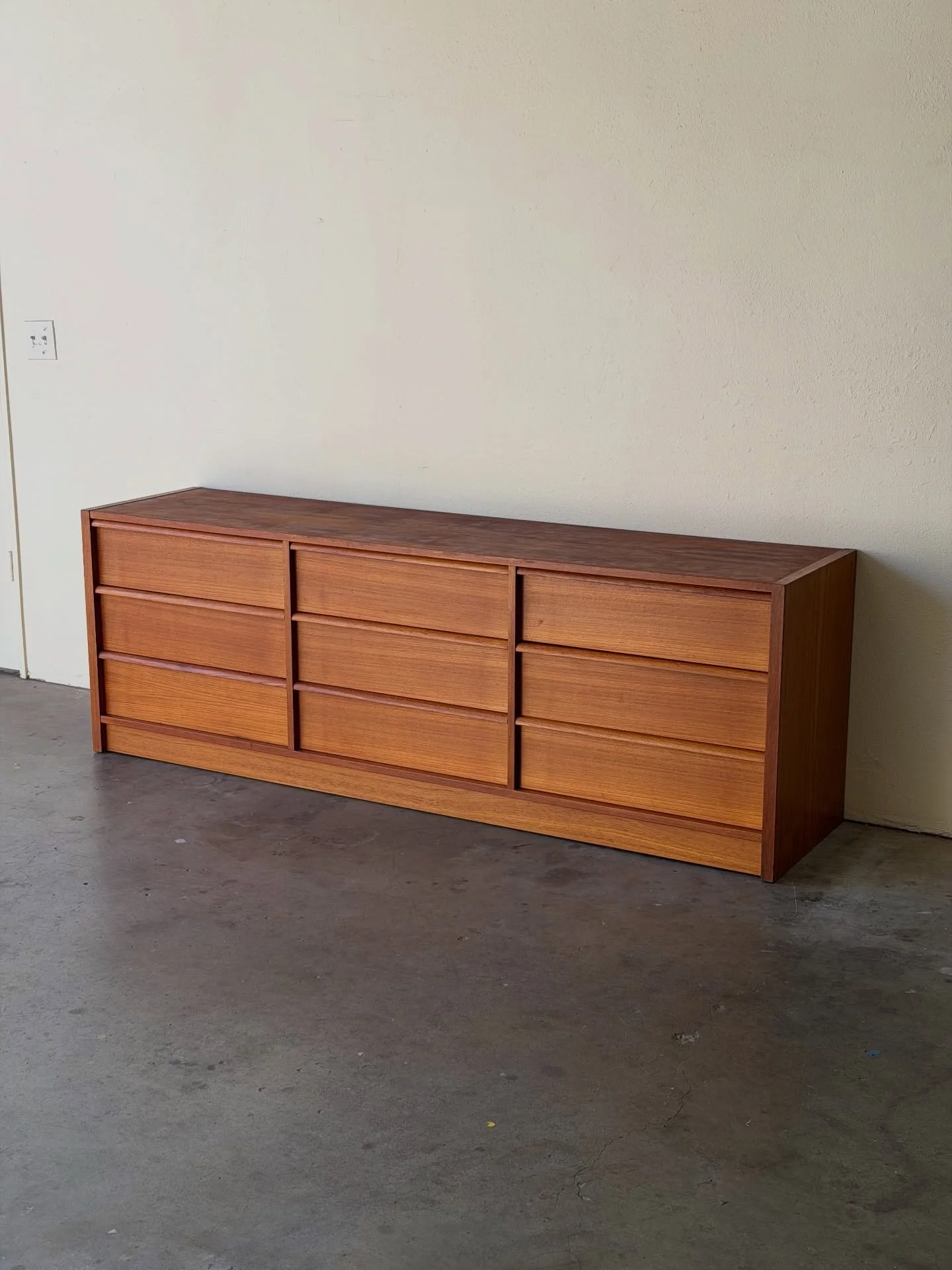 Authentic Danish Mid-Century Modern teak long dresser.
A beautifully proportioned 9-drawer piece with clean lines, warm teak grain, and a sleek Scandinavian silhouette. Perfect as a dresser, low credenza, or media console.

Features recessed pulls an