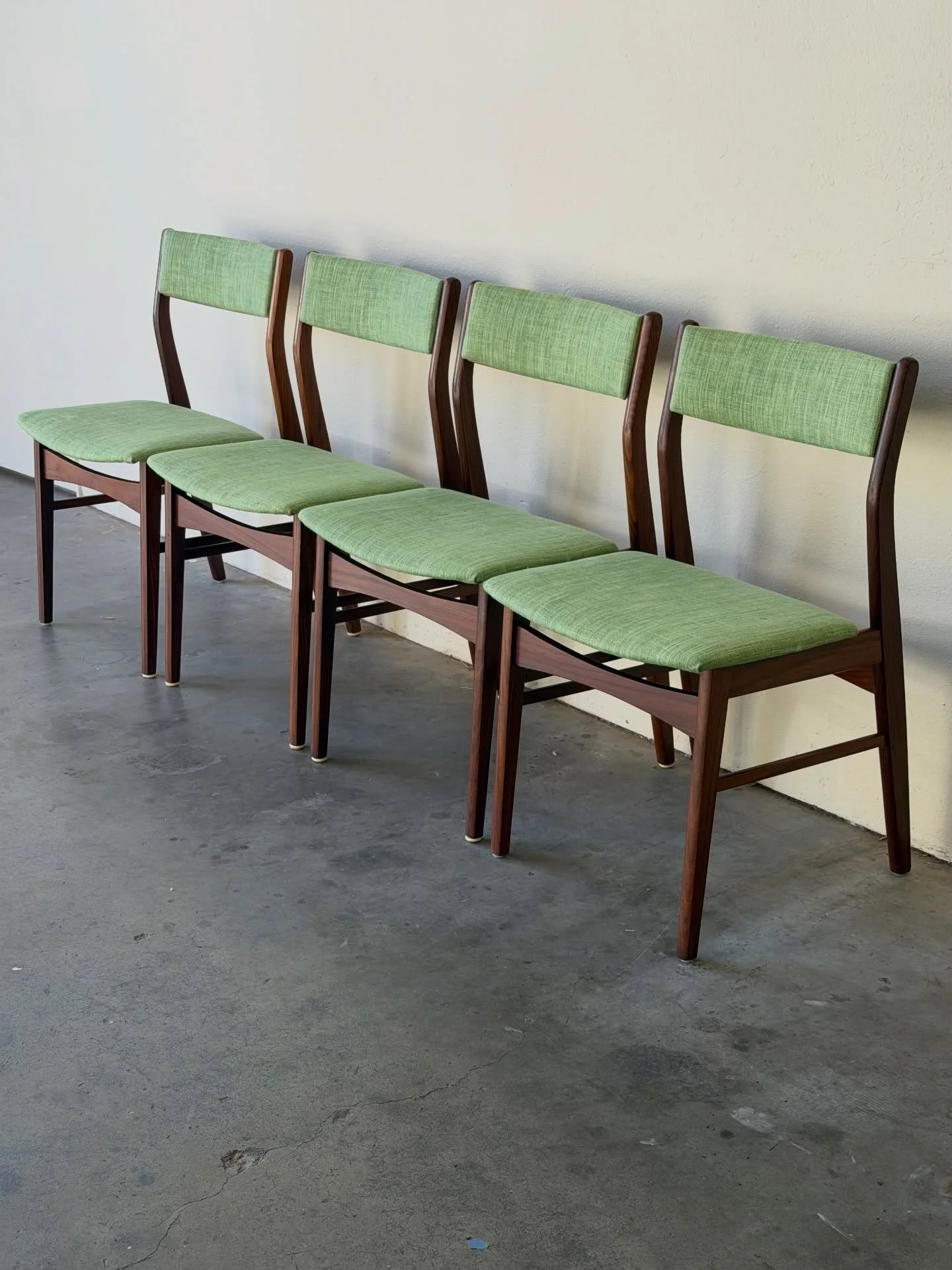 Beautiful set of four vintage Danish modern dining chairs crafted in solid teak, designed in the style of Erik Buch.

Sculpted frames with softly curved backrests and refined proportions create an elegant, timeless look. Newly upholstered in soft gre