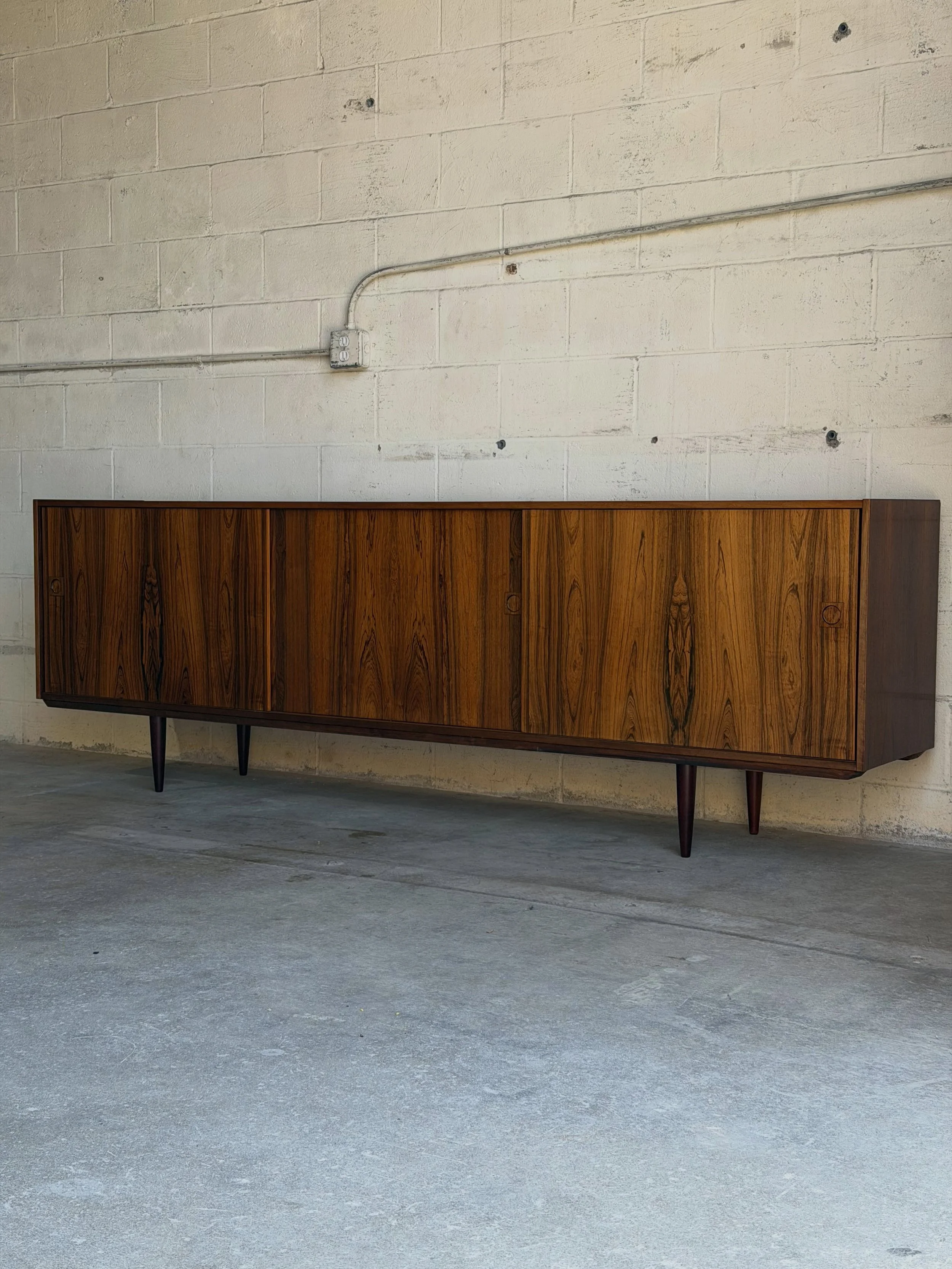 The longest credenza we&rsquo;ve ever had in the showroom 

This stunning Danish modern lowboard stretches an impressive 95.3&rdquo; and showcases some of the most beautiful rosewood grain we&rsquo;ve seen in a long time.

Featuring four sliding door