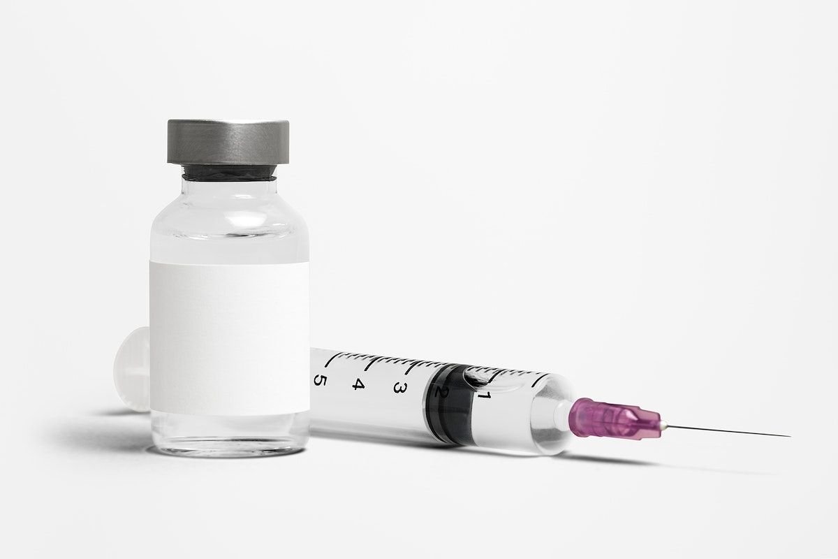 A medical vial and a syringe with a pink needle on a white background.