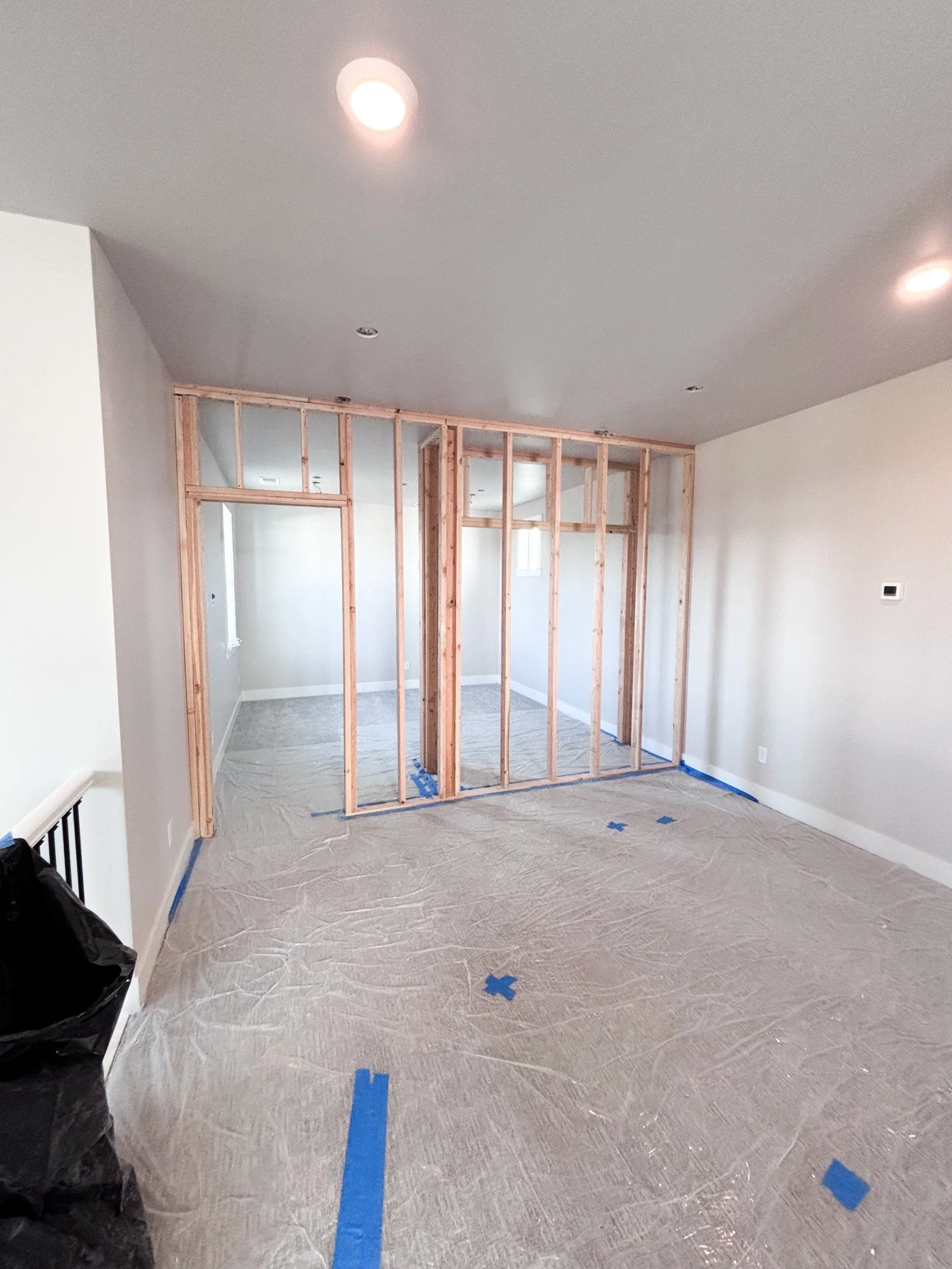 Framed wall studs installed to enclose a loft space during conversion to a bedroom in Boise, Idaho