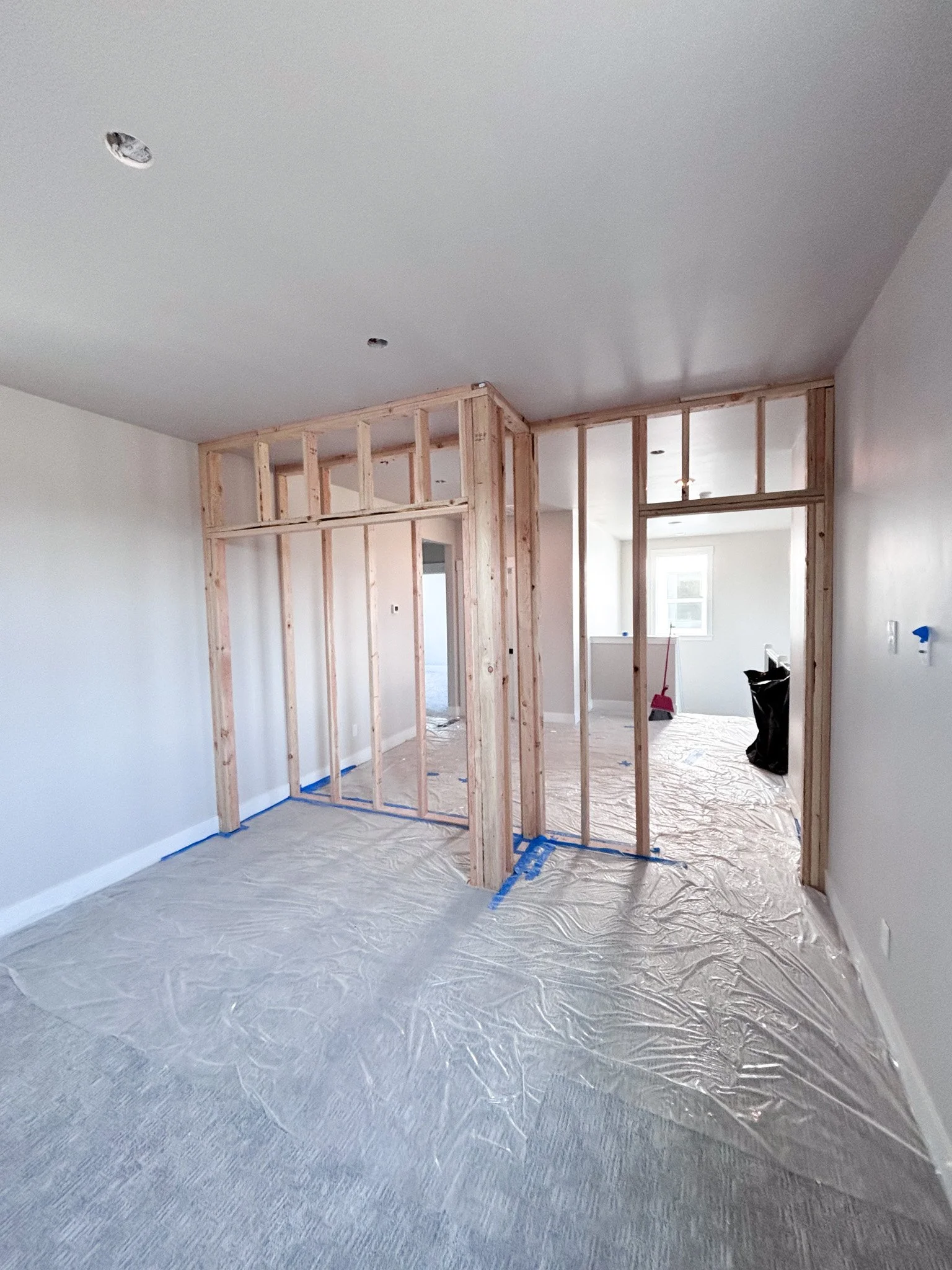 Alternate angle of loft‑to‑bedroom conversion showing open wall framing and floor protection in Boise, Idaho