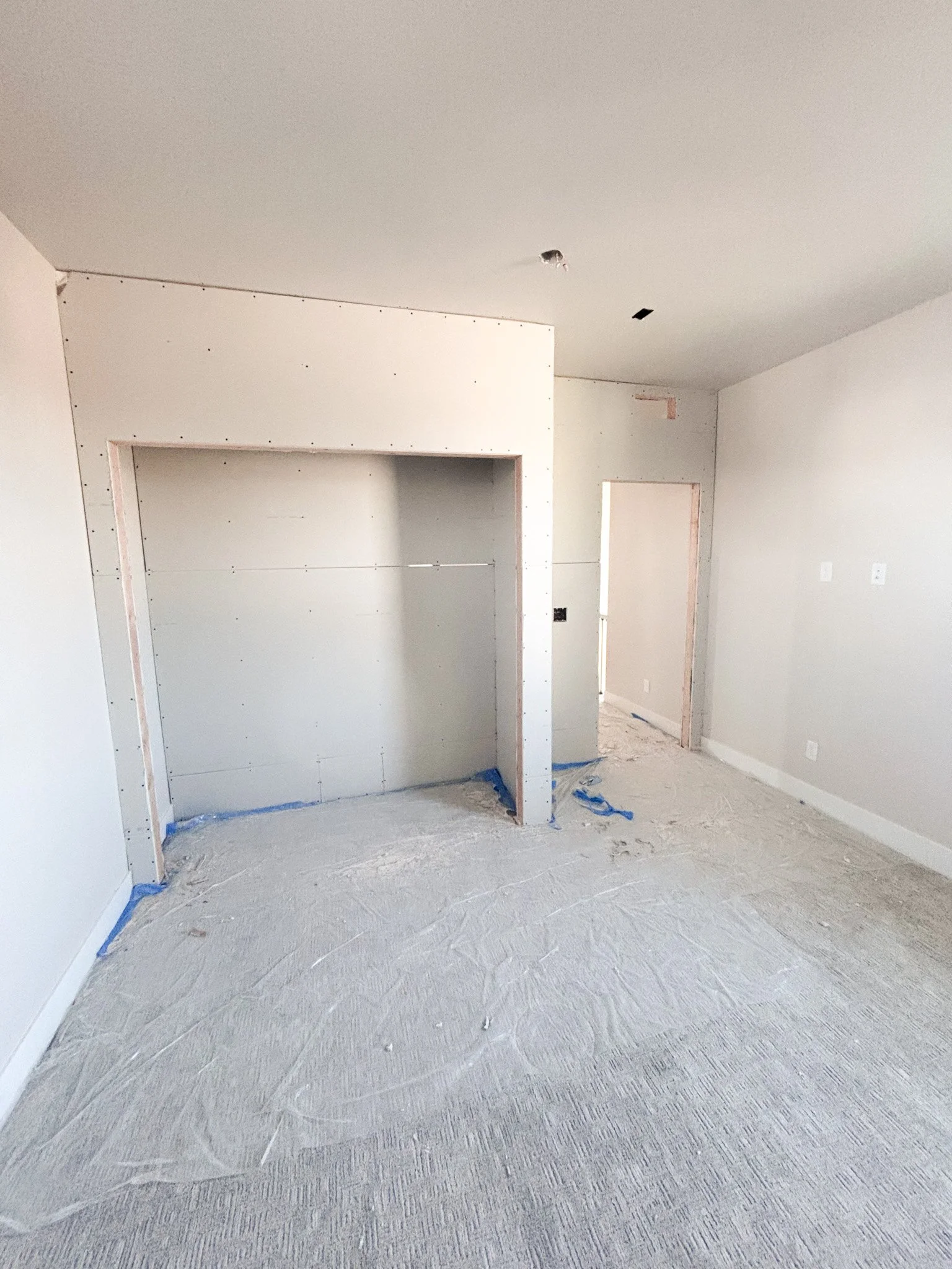 Interior view of new bedroom showing framed wall and open walkway during construction in Boise, Idaho