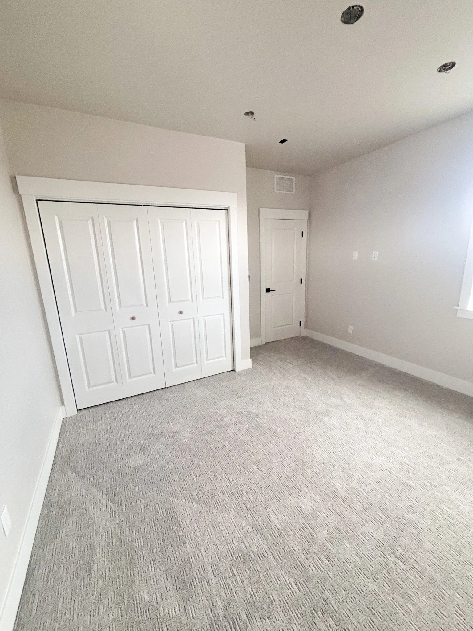 Completed bedroom addition with fresh paint and carpet in Boise, Idaho
