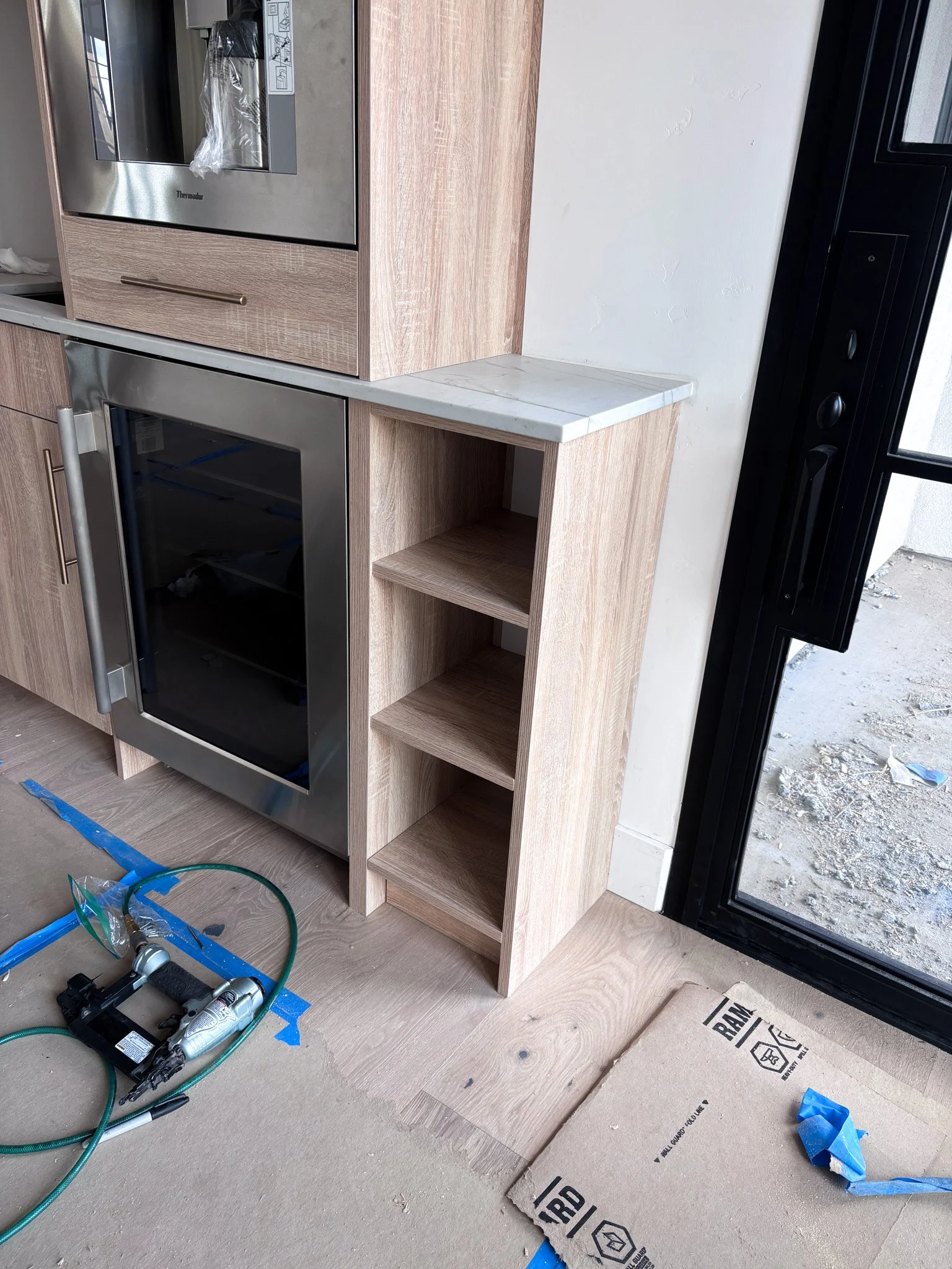 Finished coffee wet bar with symmetrical open shelving and new faucet in Eagle, Idaho
