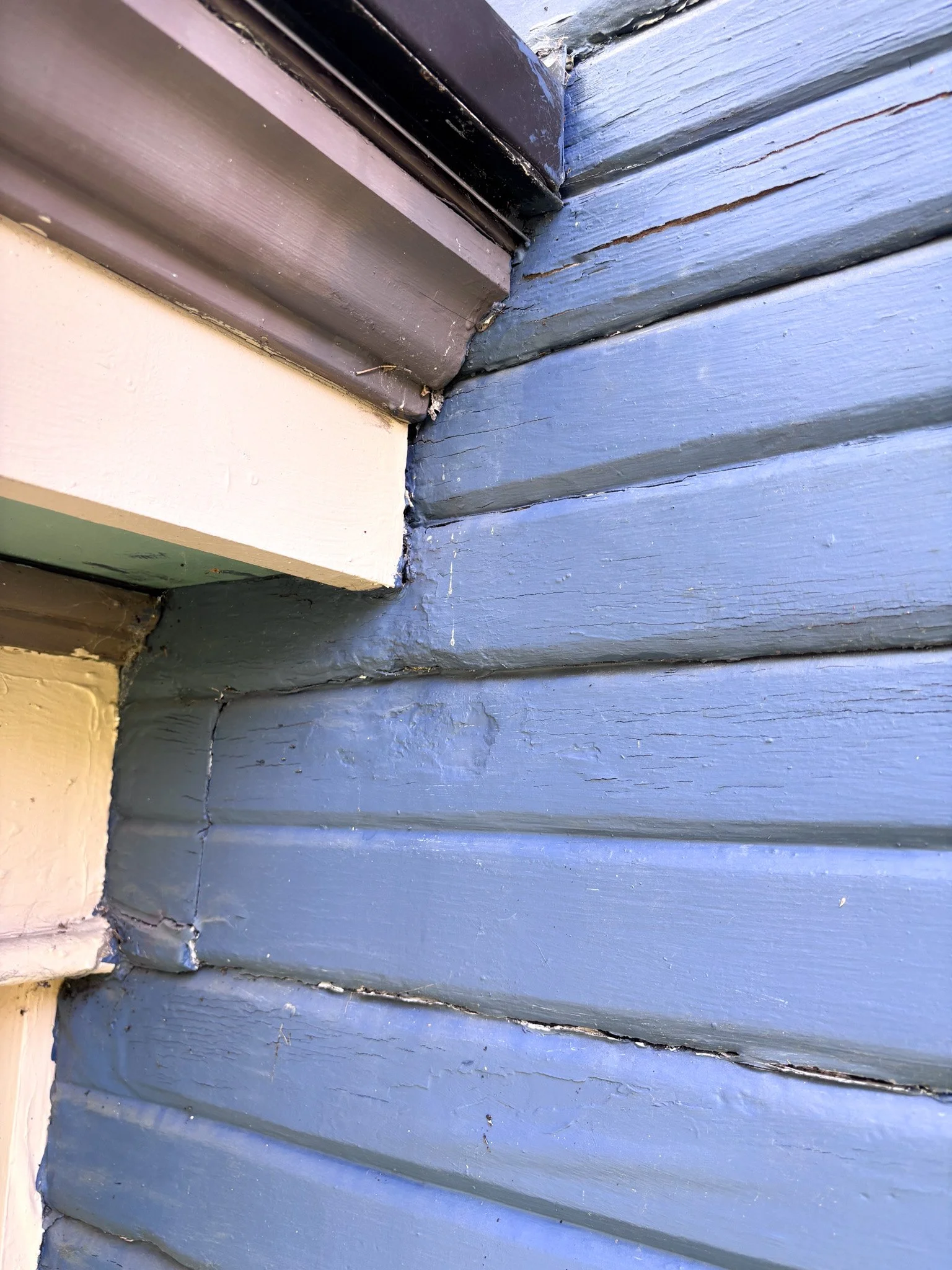 Before detail picture of gutter transition at corner where decorative trim meets blue siding in Garden City, Idaho