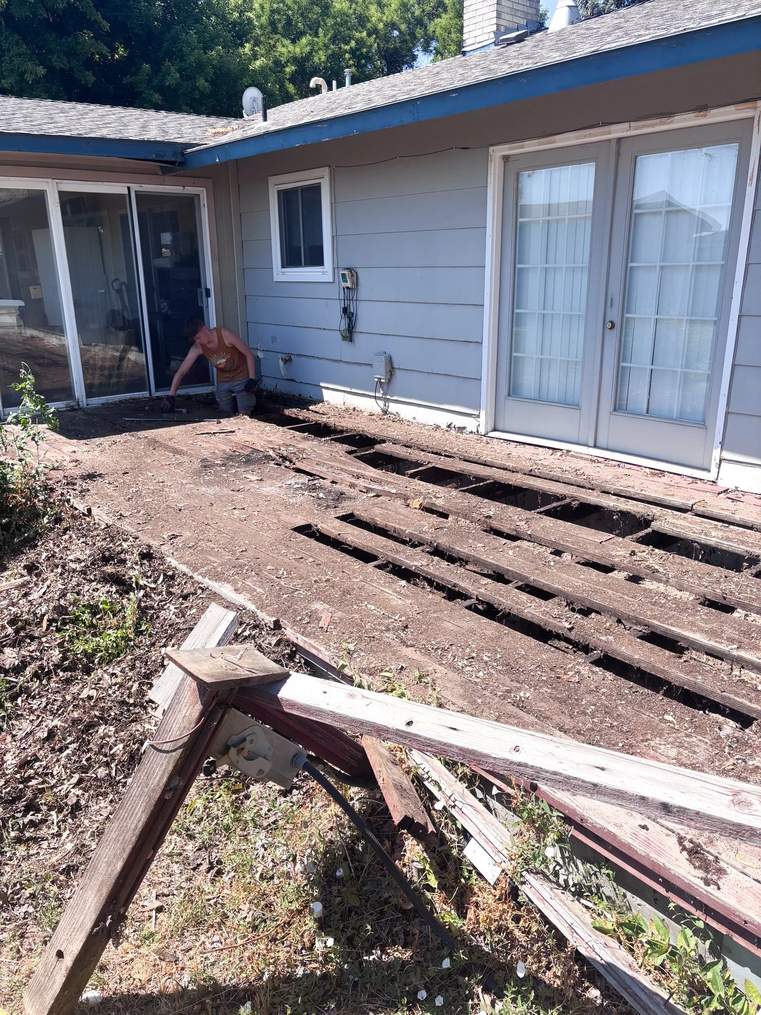 Deteriorated wood deck stripped down to rotted joists during deck demolition at a New Plymouth, Idaho home