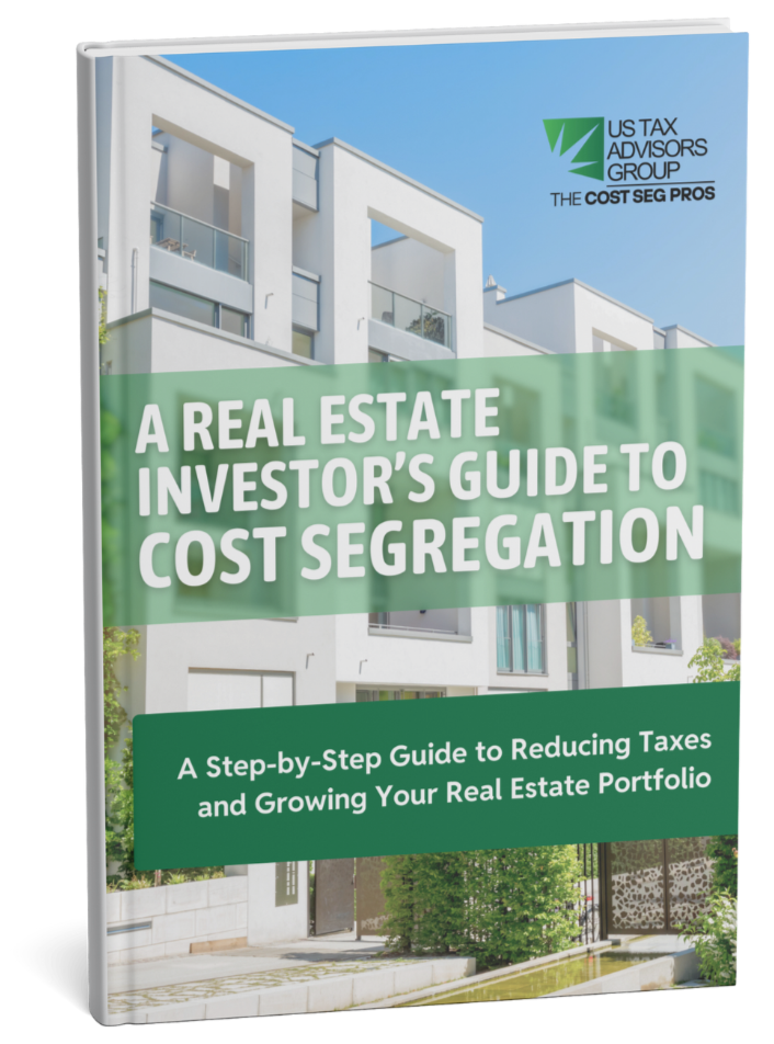 Free ebook cover titled "A Real Estate Investor's Guide to Cost Segregation" with an image of modern white residential buildings, and includes the logos of US Tax Advisors Group and The Cost Segregation Pros.