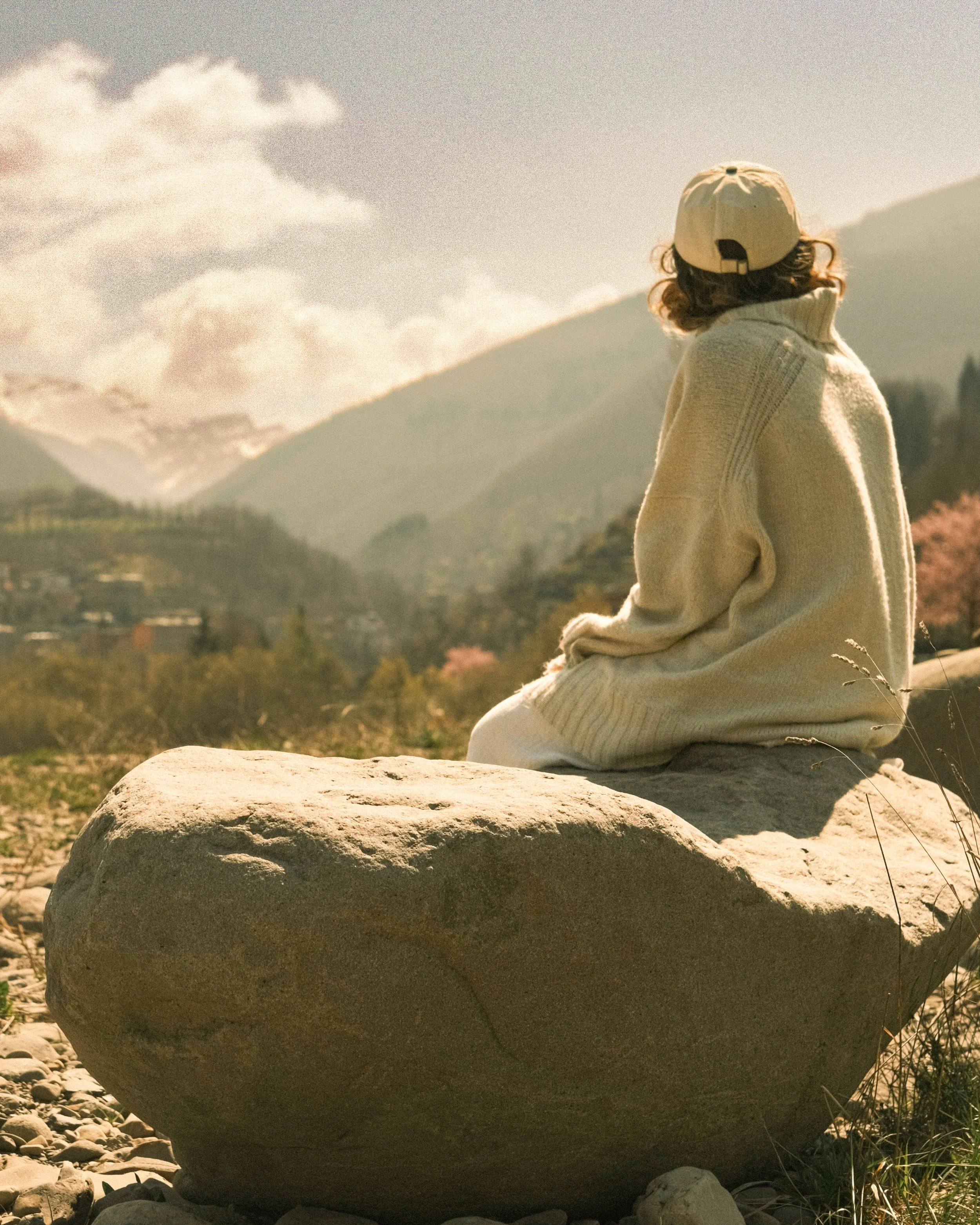 Quiet moment in nature overlooking a mountain landscape, reflecting the inspiration behind Honey x Flint artwork.