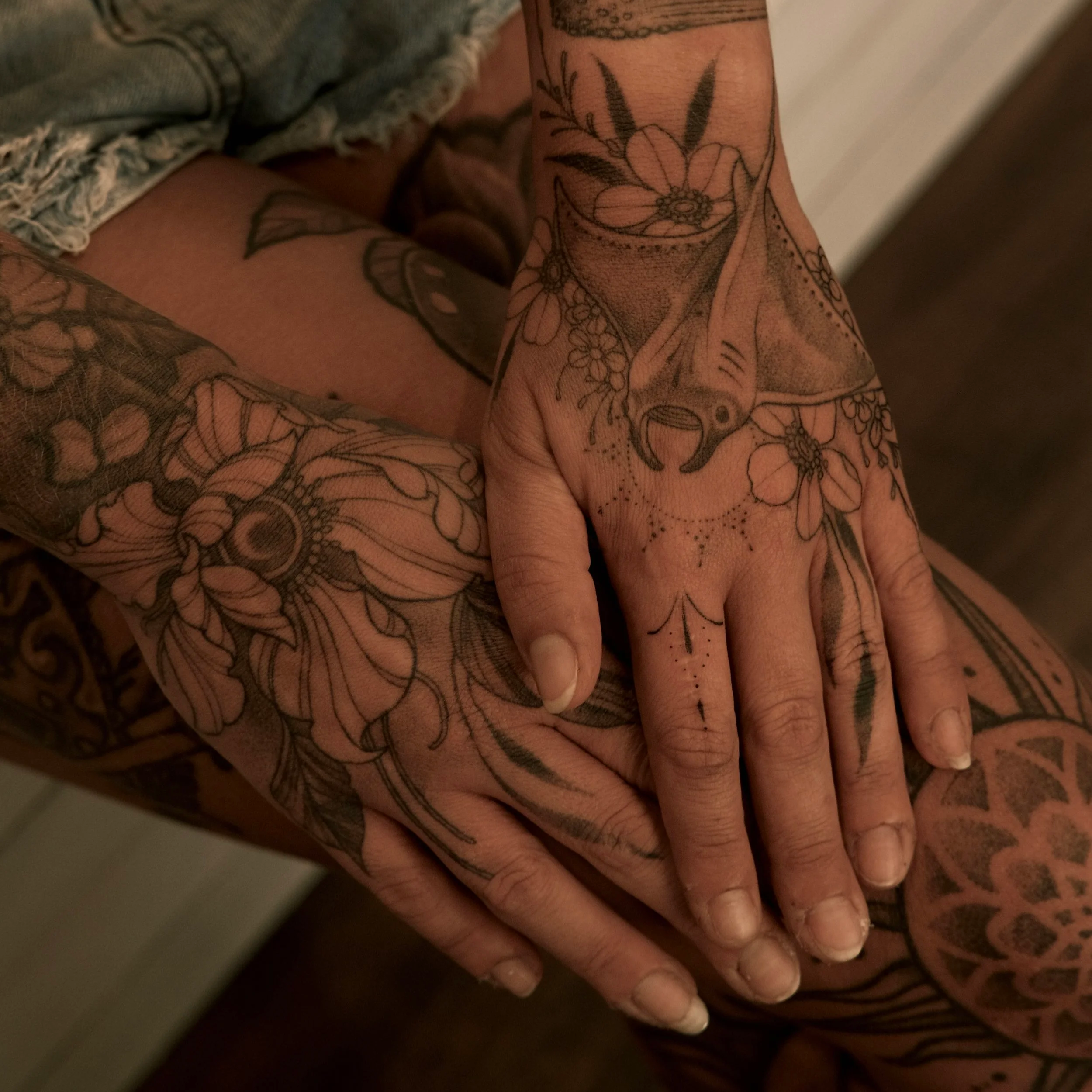 detailed botanical hand tattoos featuring florals, natural motifs, and fine line blackwork.