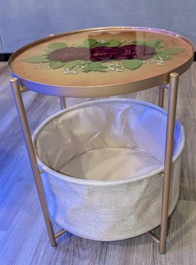 Side profile of gold resin table highlighting the grey fabric storage basket below