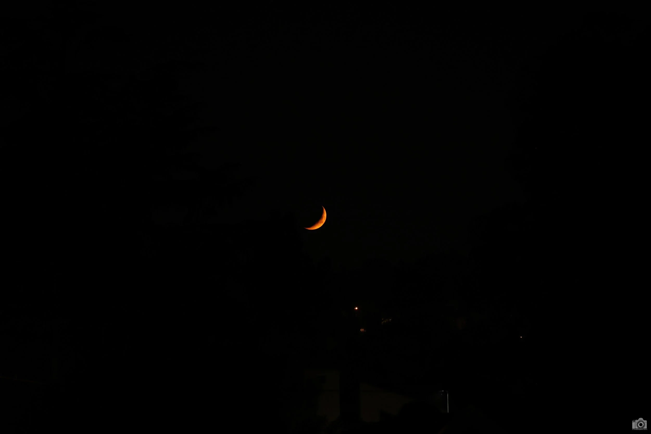 2021 - Blood Moon Sliver.  Taken from my home.  Shot with a Canon EOS R6 // RF 70-200 F4L ISO 2000 - 1/50s.