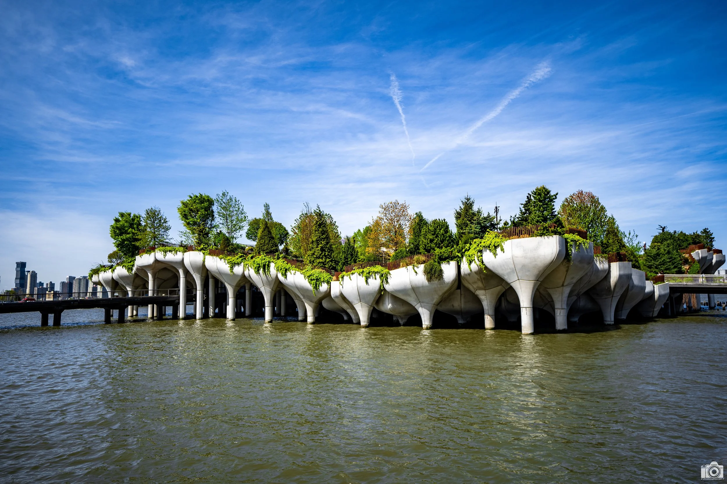 New York 2025.  Tiny Island's access point.  There are two walkways onto the island.  The island even has a concert venue.  Shot  with a Sony a7c // FE 12-24mm F4 G @ 24mm - ISO 125 - f/4 - 1/1250s.