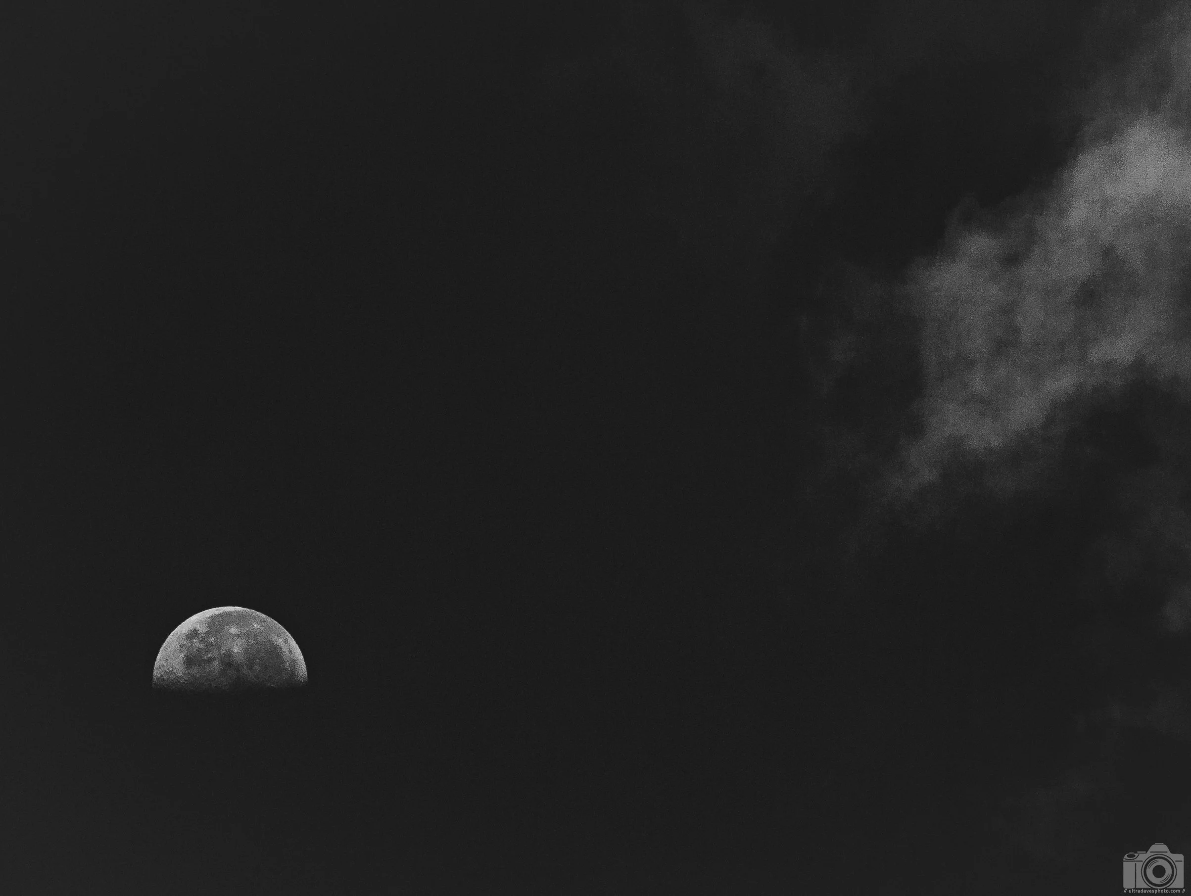 2022 - Half Moon Rising in B&W.  Aguadilla, Puerto Rico.  Shot with a Sony a7c // E 55-210mm (aps-c lens) @ 315mm f8 ISO 160 - 1/1600s.