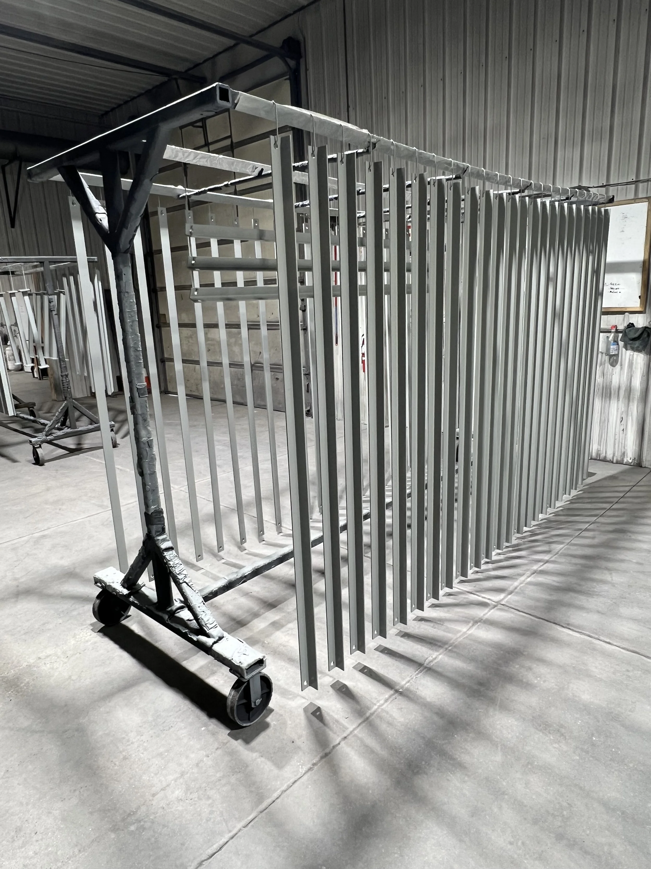Metal rolling cage in a warehouse or industrial setting.