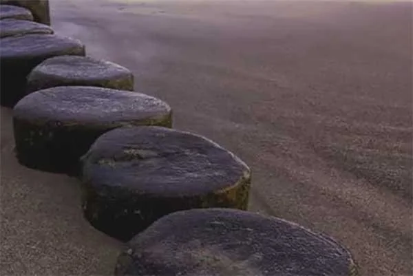 Stone pathway along the sandy beach.