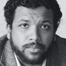 Black and white portrait of a man with curly hair and a beard