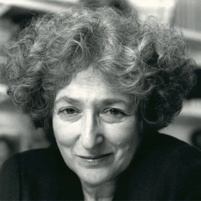 Black and white portrait of a woman with short, curly hair, smiling faintly.