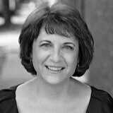 Black and white photo of a woman with short dark hair smiling