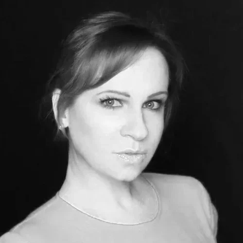 A black and white portrait of a woman with short hair, looking at the camera.
