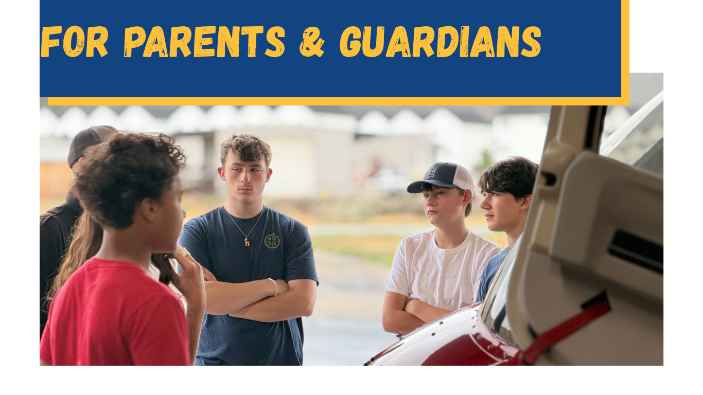 Group of teenagers gathered outdoors near a red vehicle, listening to a girl in a red shirt, with a yellow and blue banner overhead reading 'For Parents & Guardians'.