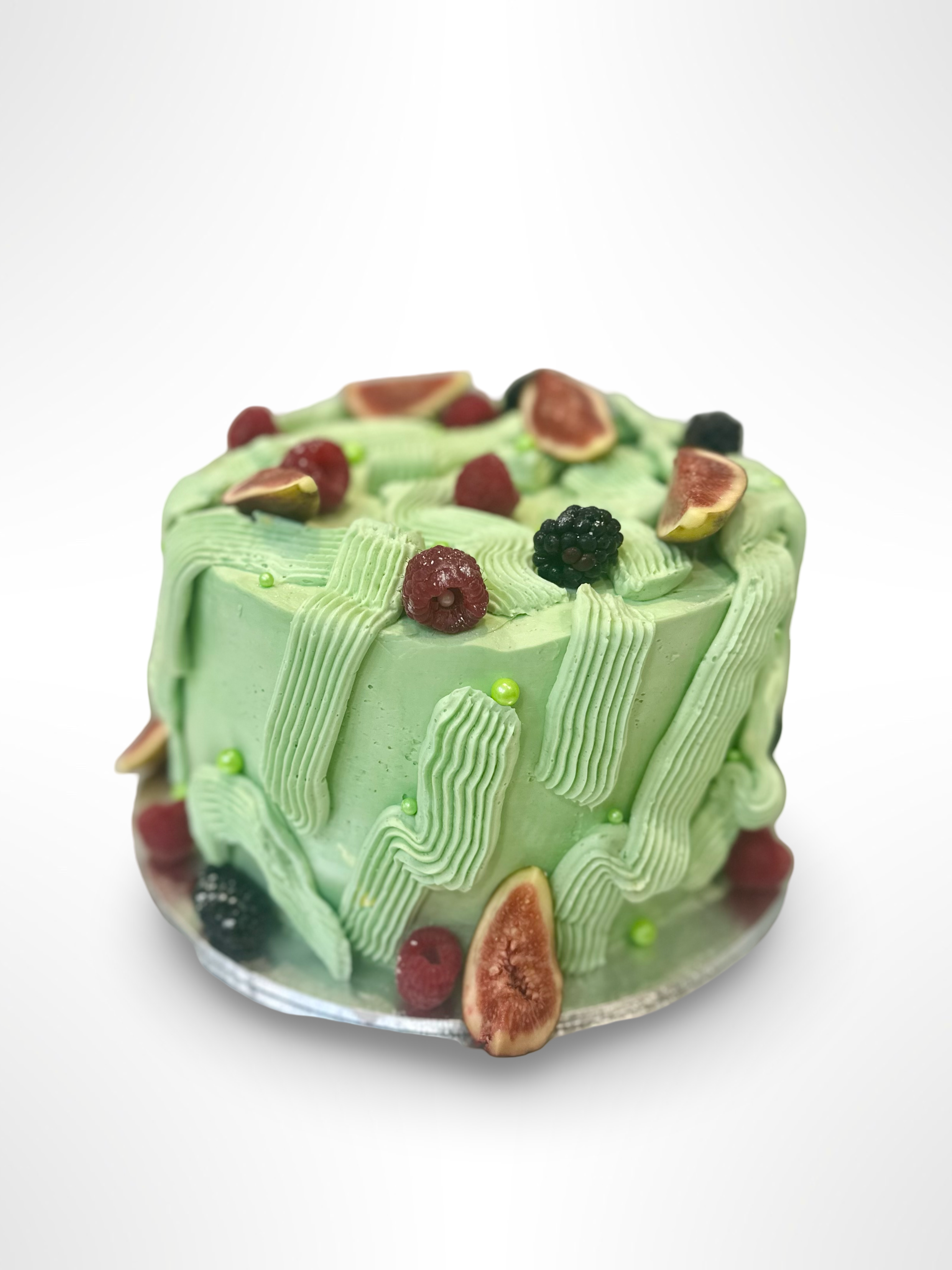 spiced carrot and cream cheese layered cake, covered in swiss butter cream