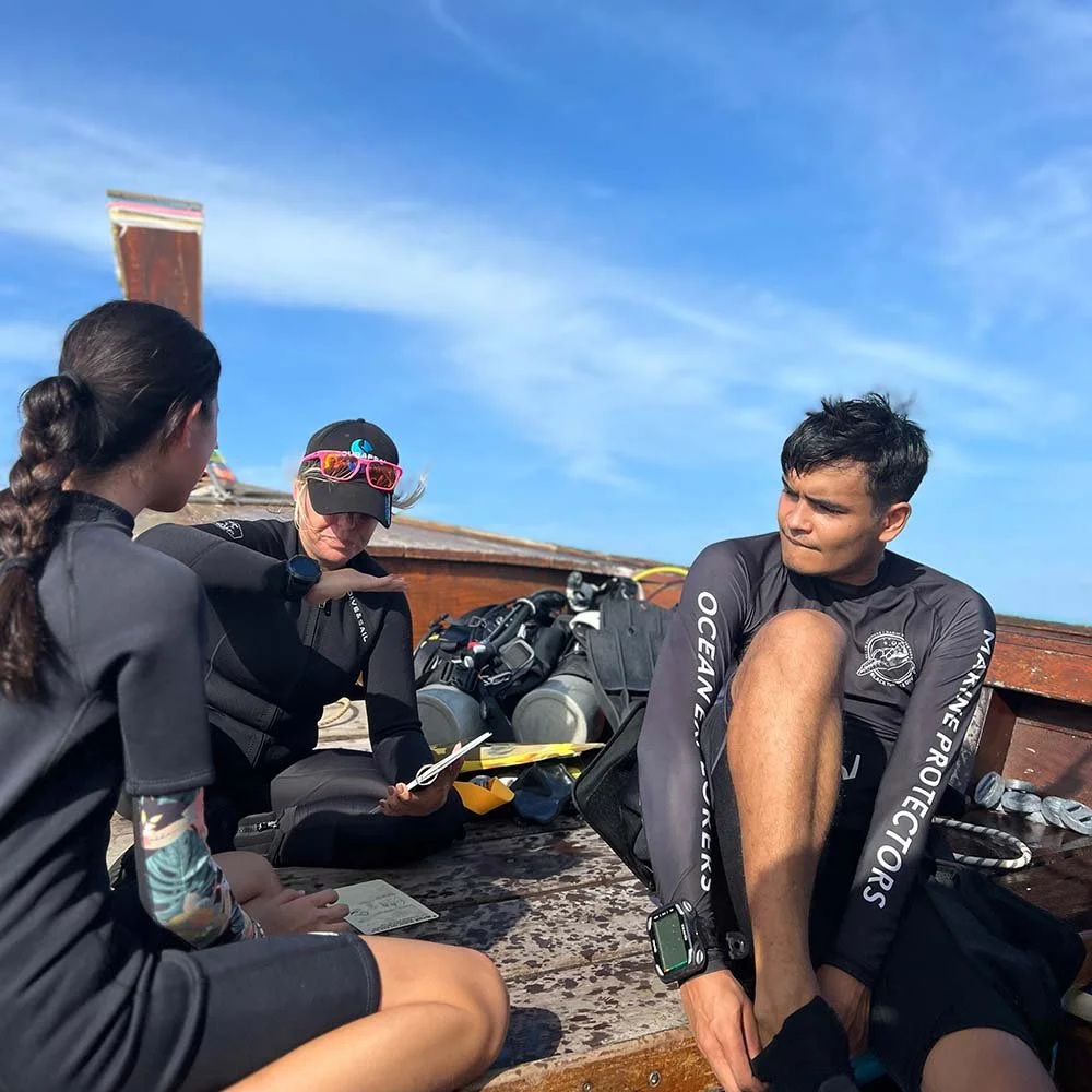 Scuba divers on a long tail boat in thailand