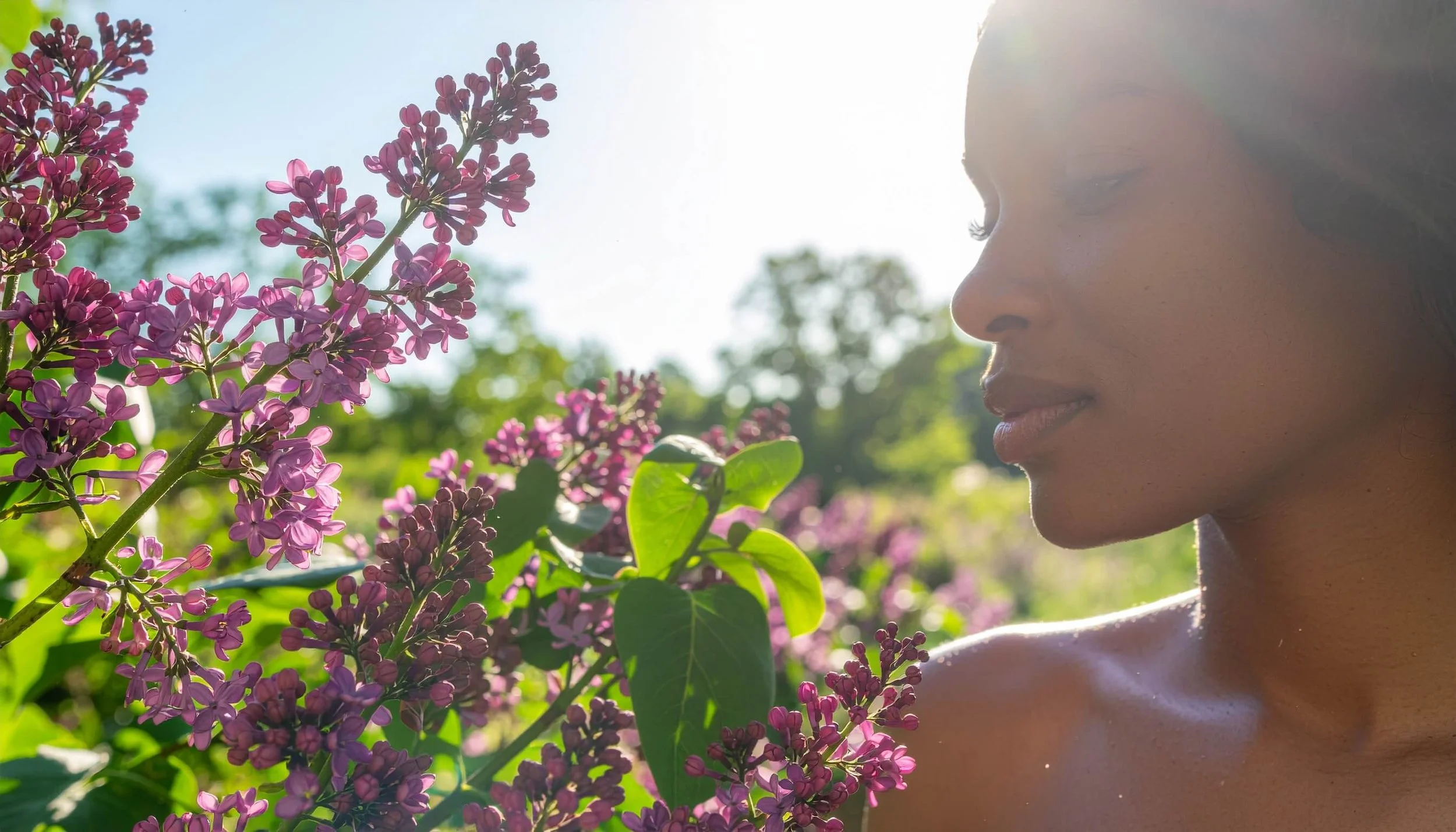 Woman enjoying spring flowers outdoors despite hay fever, representing natural ways to support immunity during allergy season.