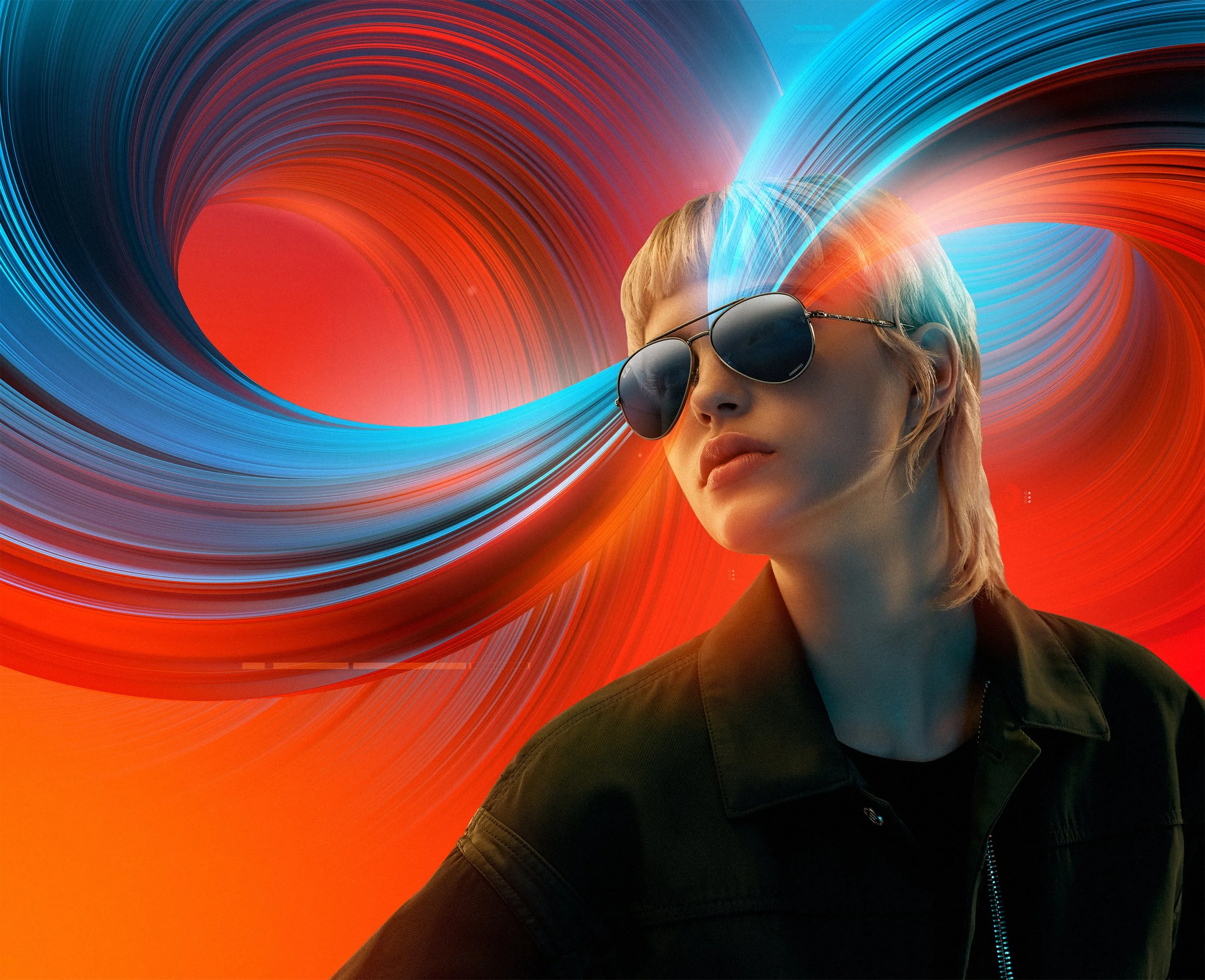 A woman with short blonde hair wearing sunglasses and a black jacket is set against a vibrant, abstract background featuring swirling red, orange, and blue lines.